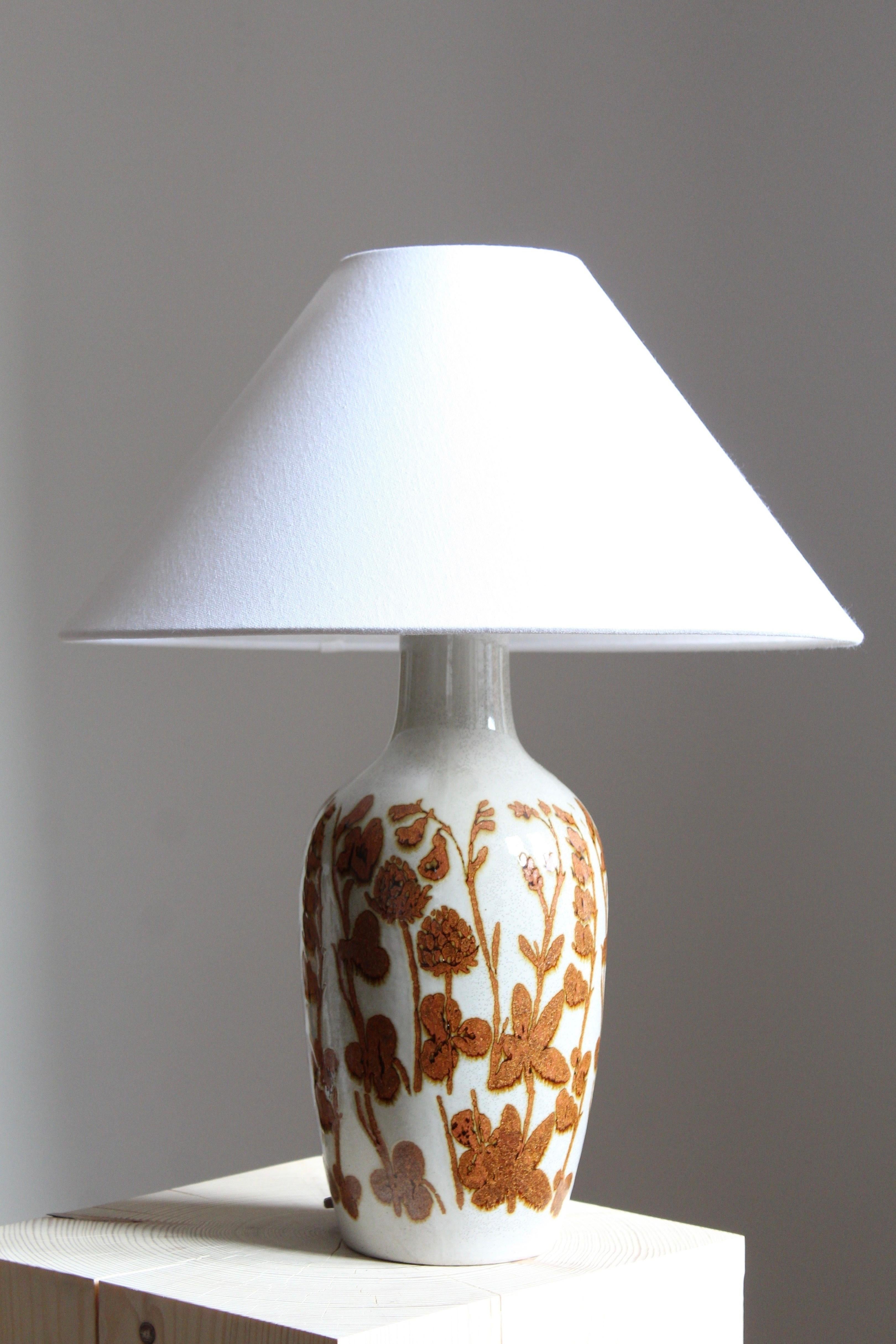A table lamp by Carl-Harry Stålhane and potter Kent Eriksson, for Carl-Harry Stålhanes own studio, Designhuset, Sweden. Signed. Shade not included.

Glaze features white-brown colors.

Other ceramicists of the period include Berndt Friberg, Axel