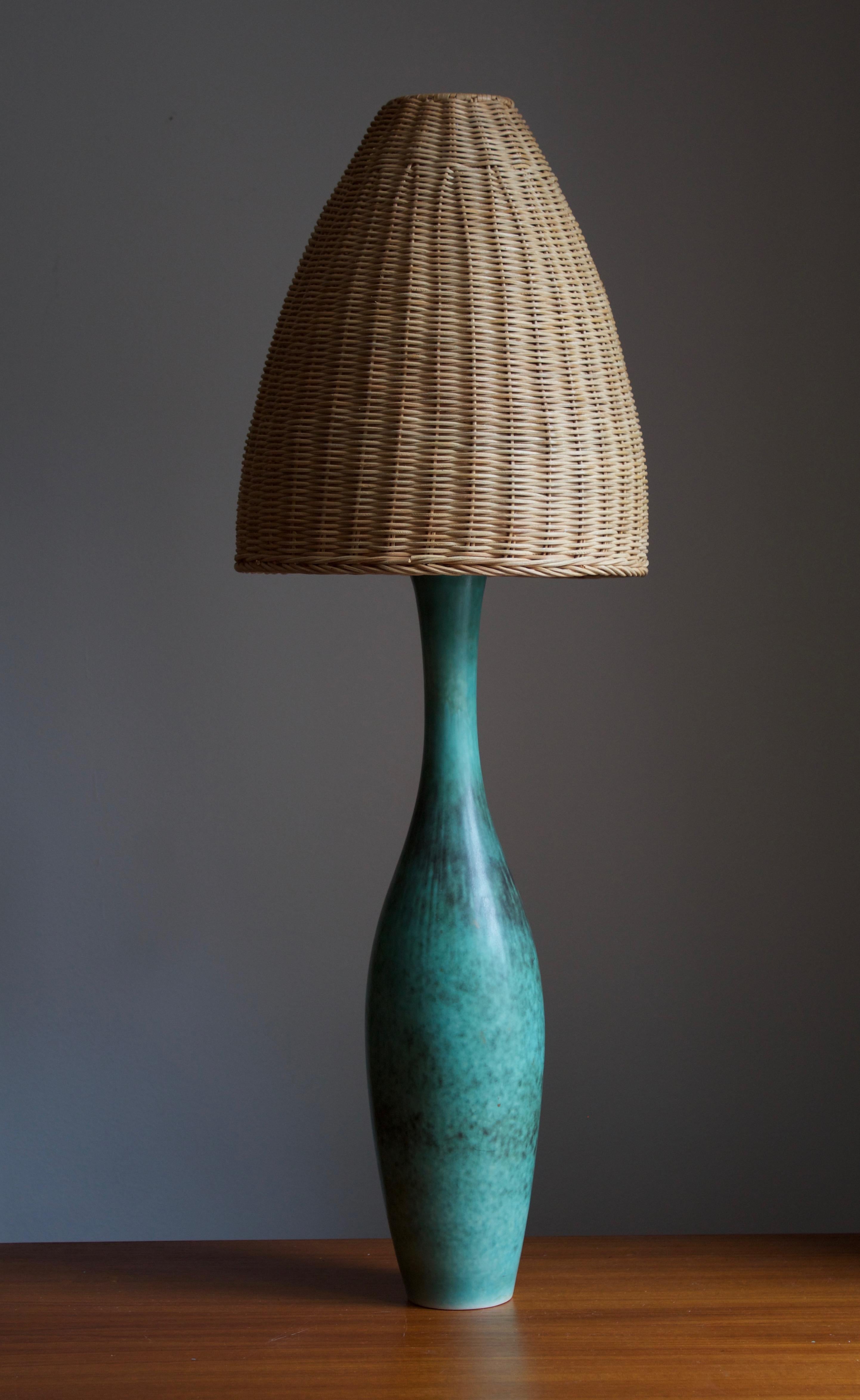 A large table lamp by Carl-Harry Stålhane for the iconic Swedish firm Rörstrand. 

Stated dimensions exclude lampshades. Height includes socket. Lampshade illustrated can be included in purchase upon request. 

Glaze features a blue-green