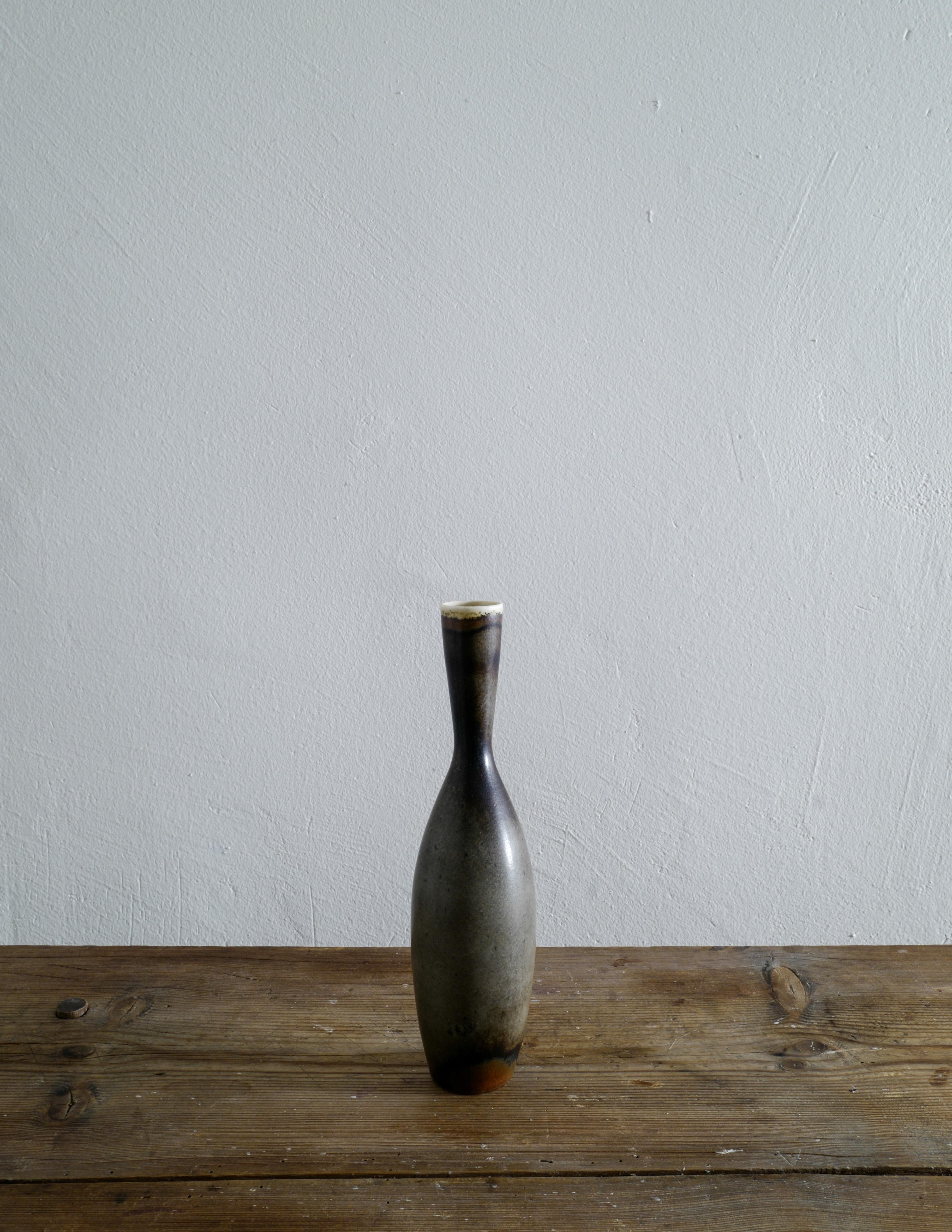 Very rare vase in black, green and brown glaze designed by Carl-Harry Stålhane and produced by Rörstrand in 1958. Vase is signed at the bottom and in good vintage condition showing minimal sings from use.