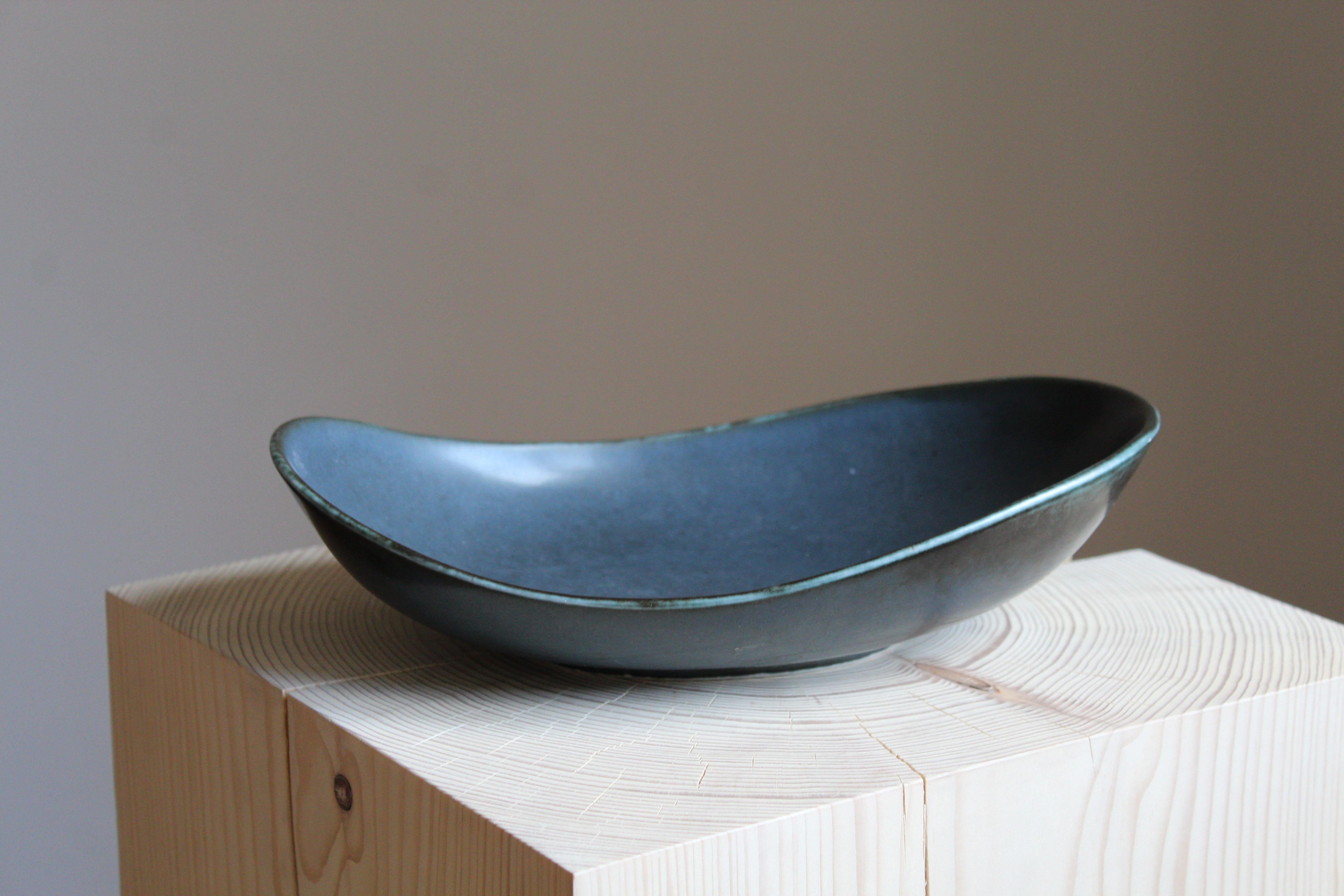 A rare and sizable bowl or dish or vide-poche by Carl-Harry Stålhane for the iconic Swedish firm Rörstrand, 1950s, Sweden. Marked and signed.

Other ceramicists of the period include Berndt Friberg, Axel Salto, Arne Bang and Wilhelm Kåge.