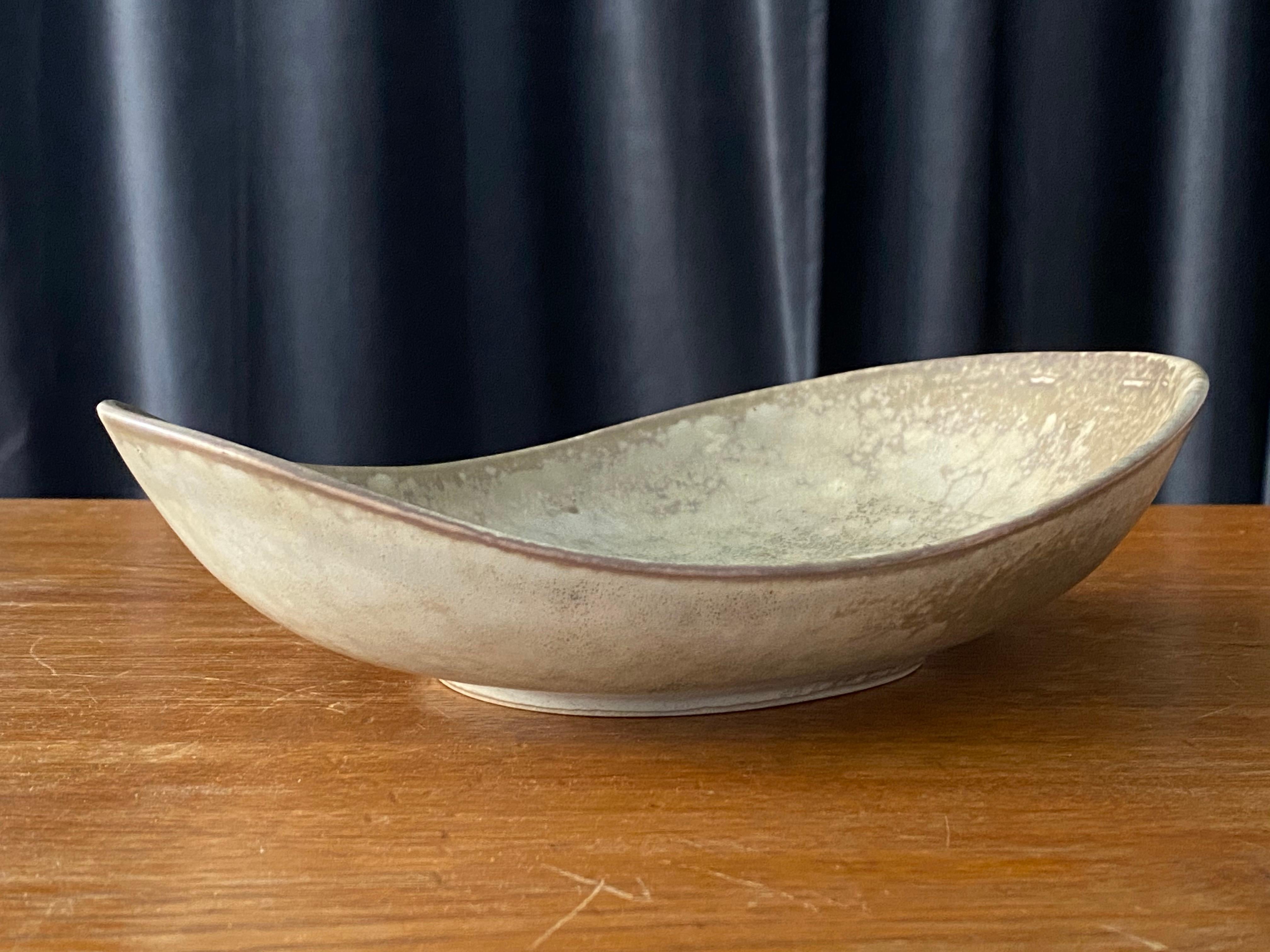 A rare and sizable bowl or dish by Carl-Harry Stålhane for the iconic Swedish firm Rörstrand. Of studio-level quality, 1950s, Sweden. Factory second. Marked and signed.

Other ceramicists of the period include Berndt Friberg, Axel Salto, Arne Bang