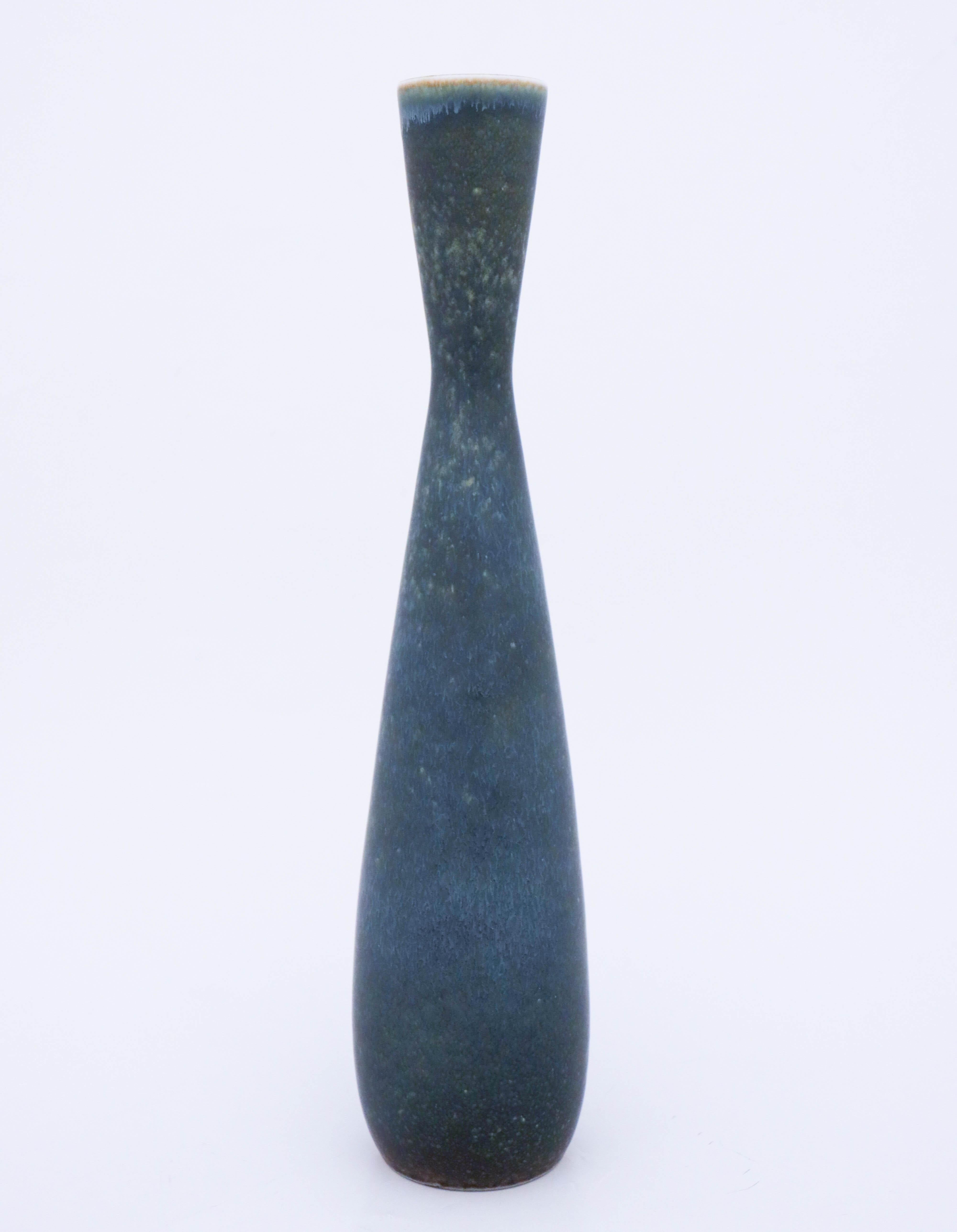 A beautiful midcentury Swedish vase in stoneware by Rörstrand, designed by Carl-Harry Stålhane. This large and unique vase was produced in 1960, it is marked as 2nd quality and do have a white mark in the glaze.