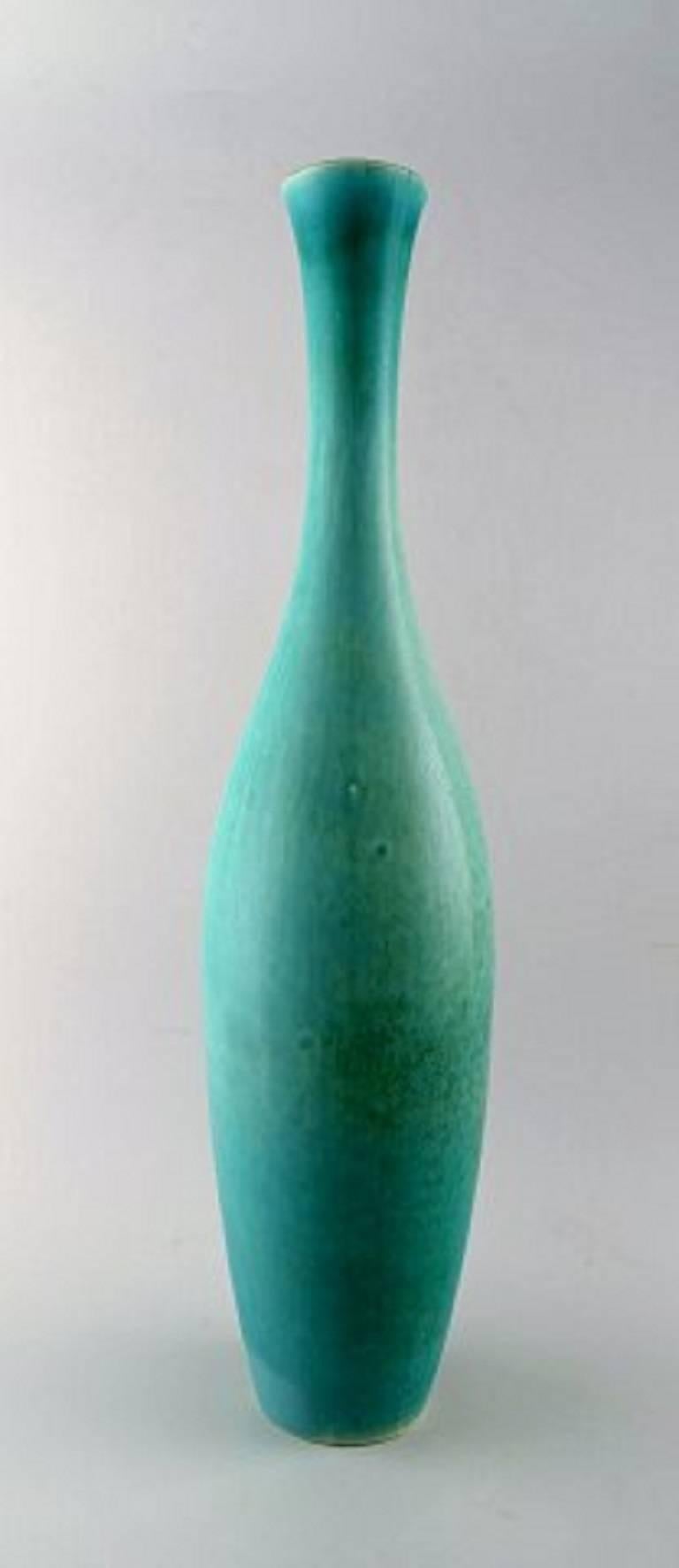 Carl Harry Stålhane, Rörstrand very large and rare floor vase in ceramics.
Beautiful glaze in green shades.
Perfect condition.
2nd. Assortment.
Measures: 56 x 13 cm.