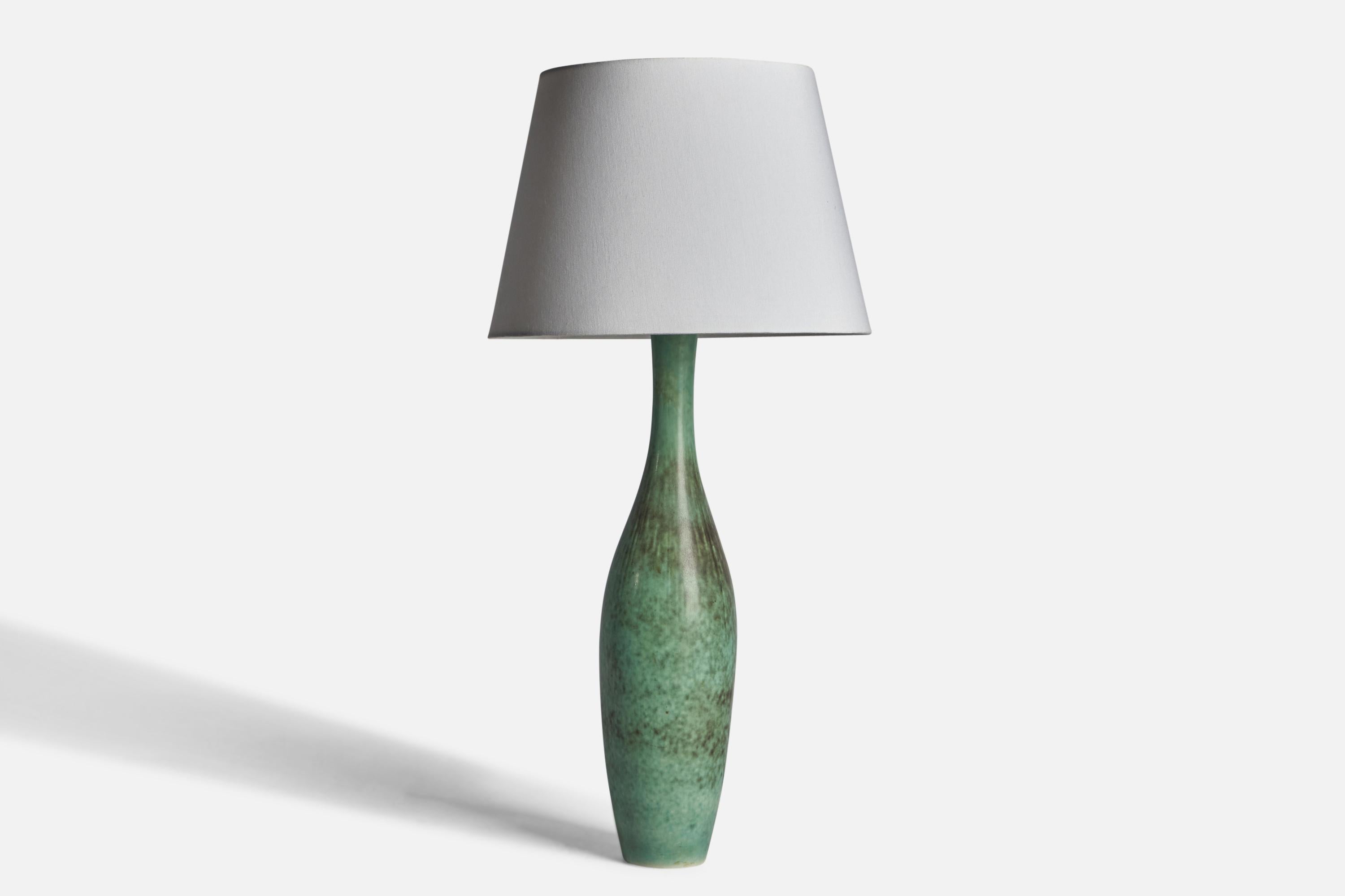 A sizeable green-glazed stoneware table lamp designed Carl-Harry Stålhane and produced by Rörstrand, Sweden, 1950s.

Dimensions of Lamp (inches): 24” H x 5.5” Diameter
Dimensions of Shade (inches): 10” Top Diameter x 14