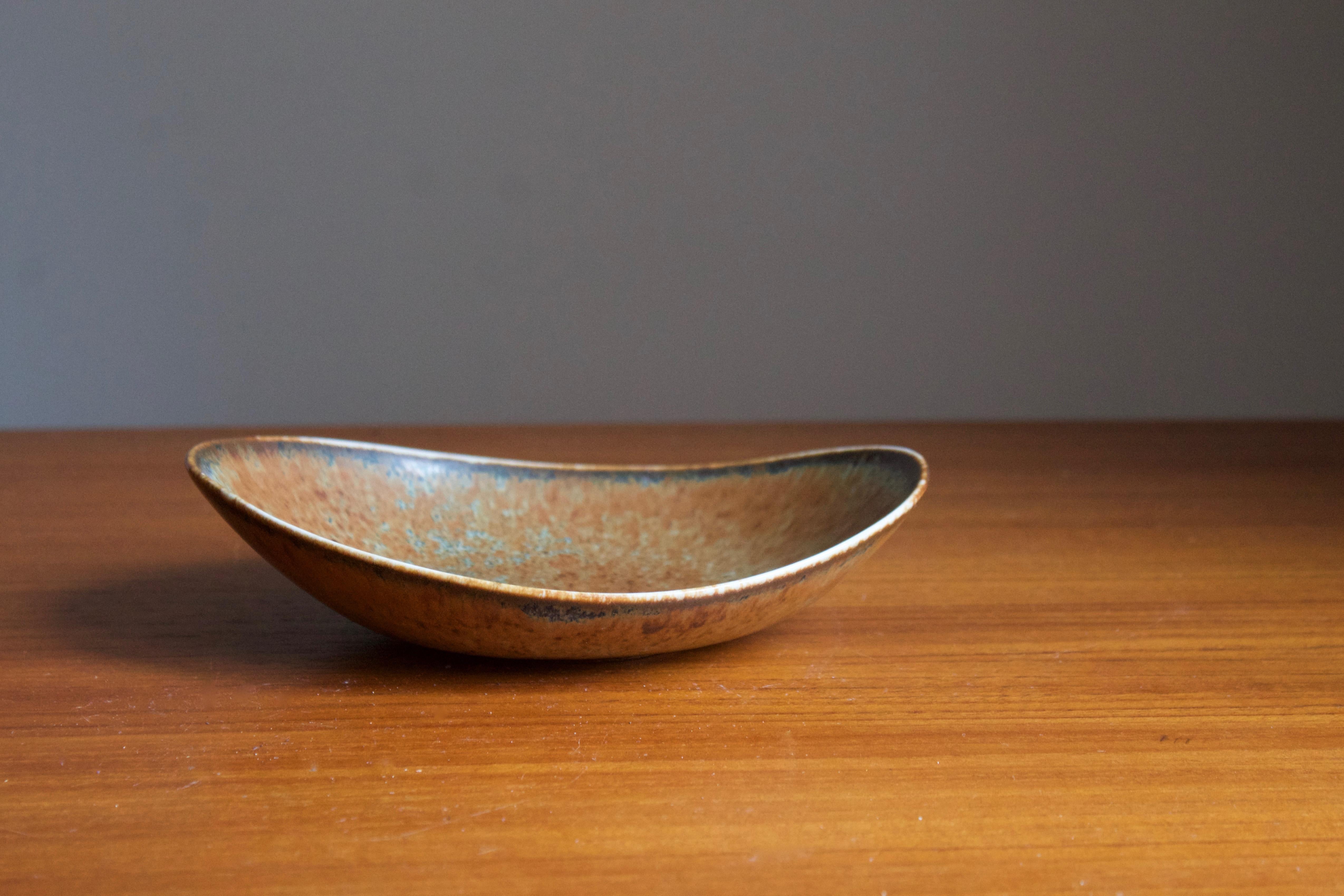 A bowl or dish or vide-poche by Carl-Harry Stålhane for the iconic Swedish firm Rörstrand, 1950s, Sweden. Marked and signed.

Other ceramicists of the period include Berndt Friberg, Axel Salto, Arne Bang and Wilhelm Kåge.