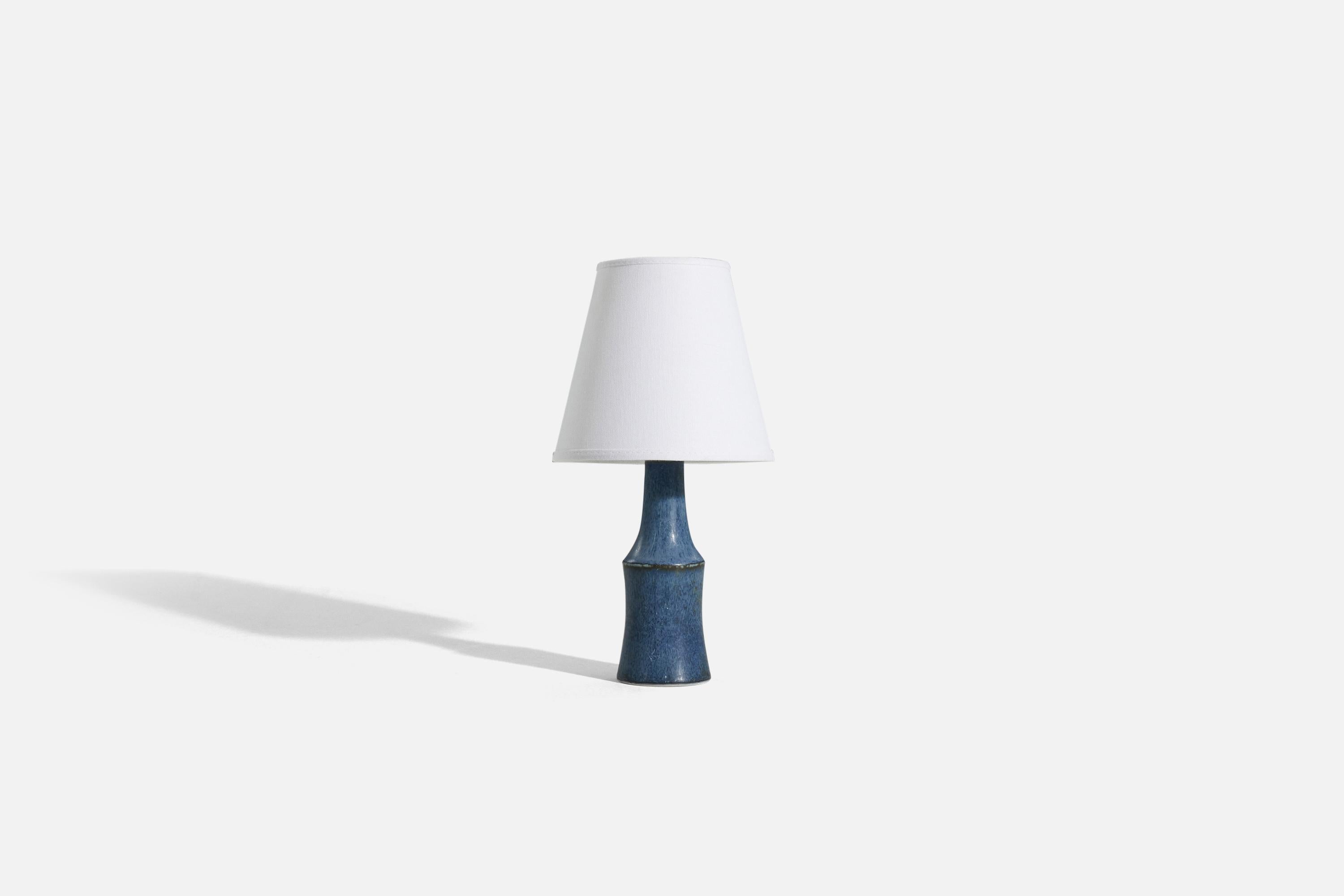 A blue, glazed stoneware table lamp designed by Carl-Harry Stålhane and produced by Rörstrand, Sweden, 1960s. 

Sold without lampshade. 
Dimensions of Lamp (inches) : 9.125 x 2.9375 x 2.9375 (H x W x D)
Dimensions of Shade (inches) : 4 x 6.75 x 6.25