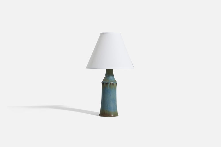 A blue-glazed stoneware table lamp designed by Carl-Harry Stålhane and produced by Rörstrand, Sweden, c. 1960s. 

Sold without lampshade. 
Dimensions of lamp (inches) : 14.0625 x 4 x 4 (H x W x D)
Dimensions of shade (inches) : 4 x 10 x 8 (T x B