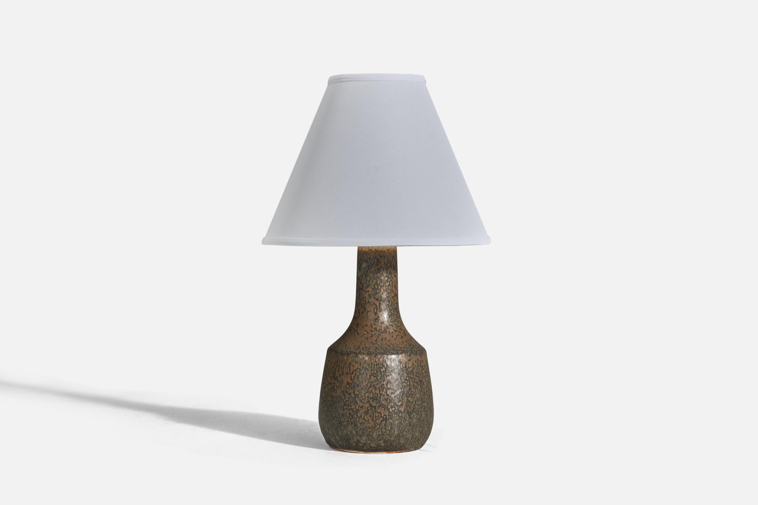 A brown glazed stoneware table lamp designed and produced by Carl-Harry Stålhane, Sweden, 1960s.

Sold without Lampshade
Dimensions of Lamp (inches) : 10.75 x 5.06 x 5.06 (Height x Width x Depth)
Dimensions of Lampshade (inches) : 4 x 10 x 8