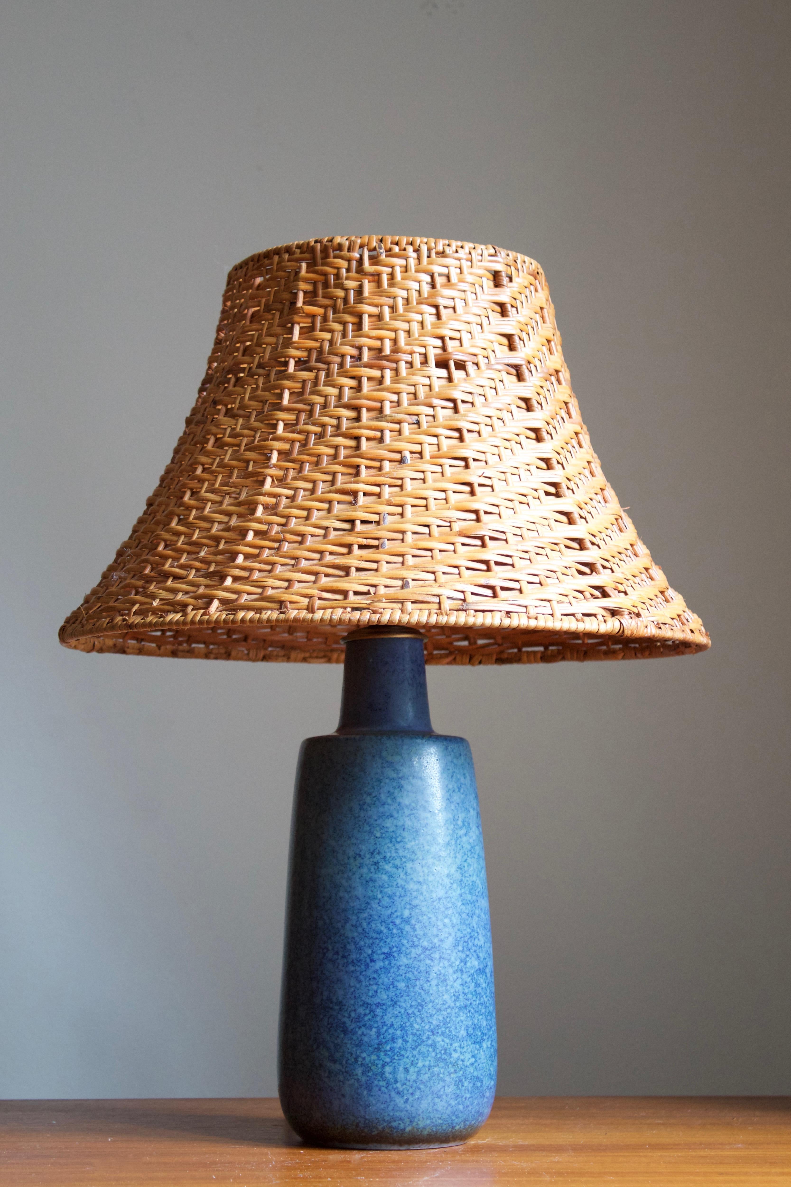 A table lamp by Carl-Harry Stålhane for the iconic Swedish firm Rörstrand. 

Stated dimensions exclude lampshades. Height includes socket. Lampshade illustrated can be included in purchase upon request.

Glaze features a blue color.

Other