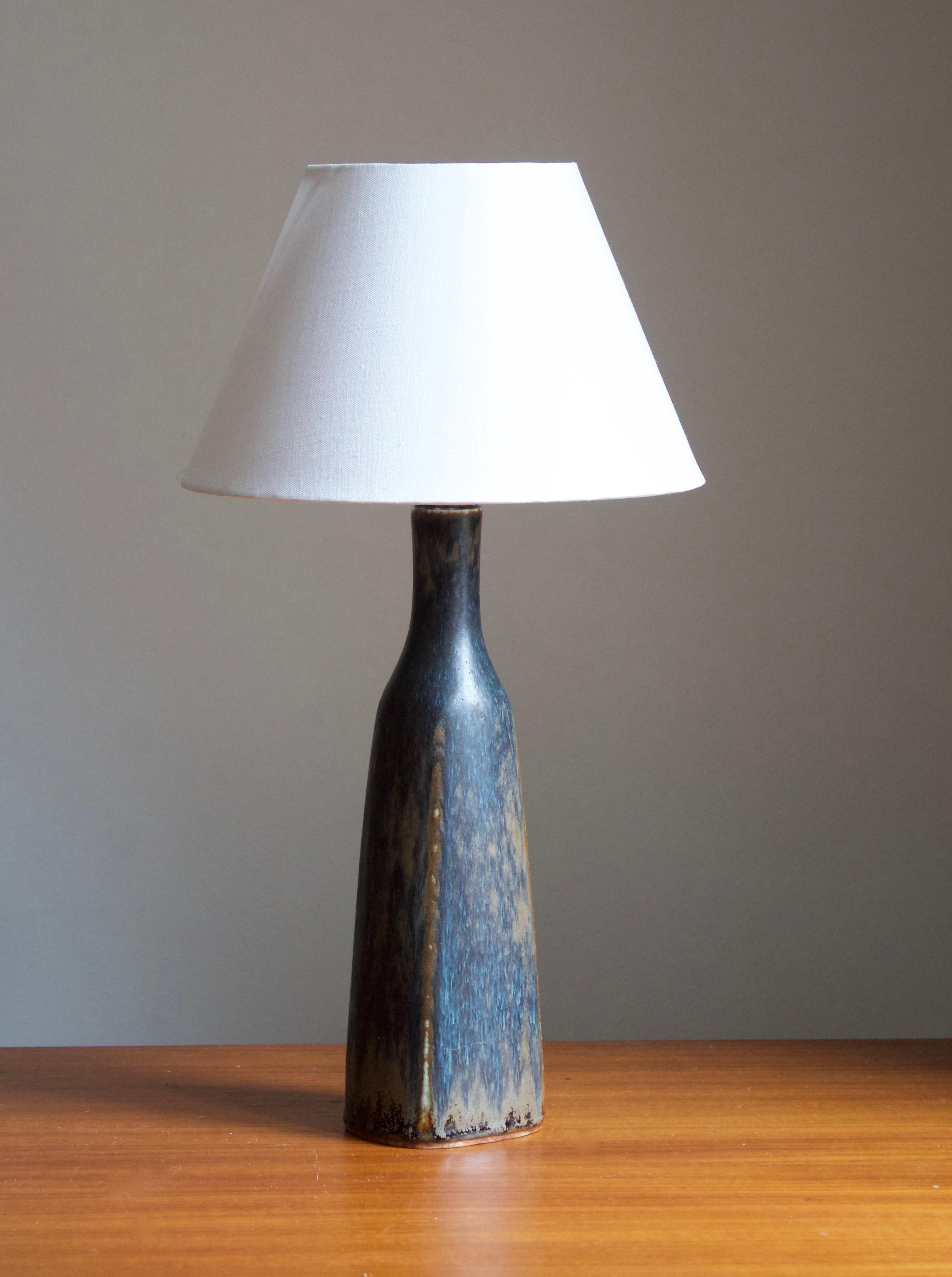 A table lamp by Carl-Harry Stålhane for the iconic Swedish firm Rörstrand. 

Stated dimensions exclude lampshade. Height includes socket. Sold without lampshade.

Glaze features brown-blue colors.

Other ceramicists of the period include Berndt