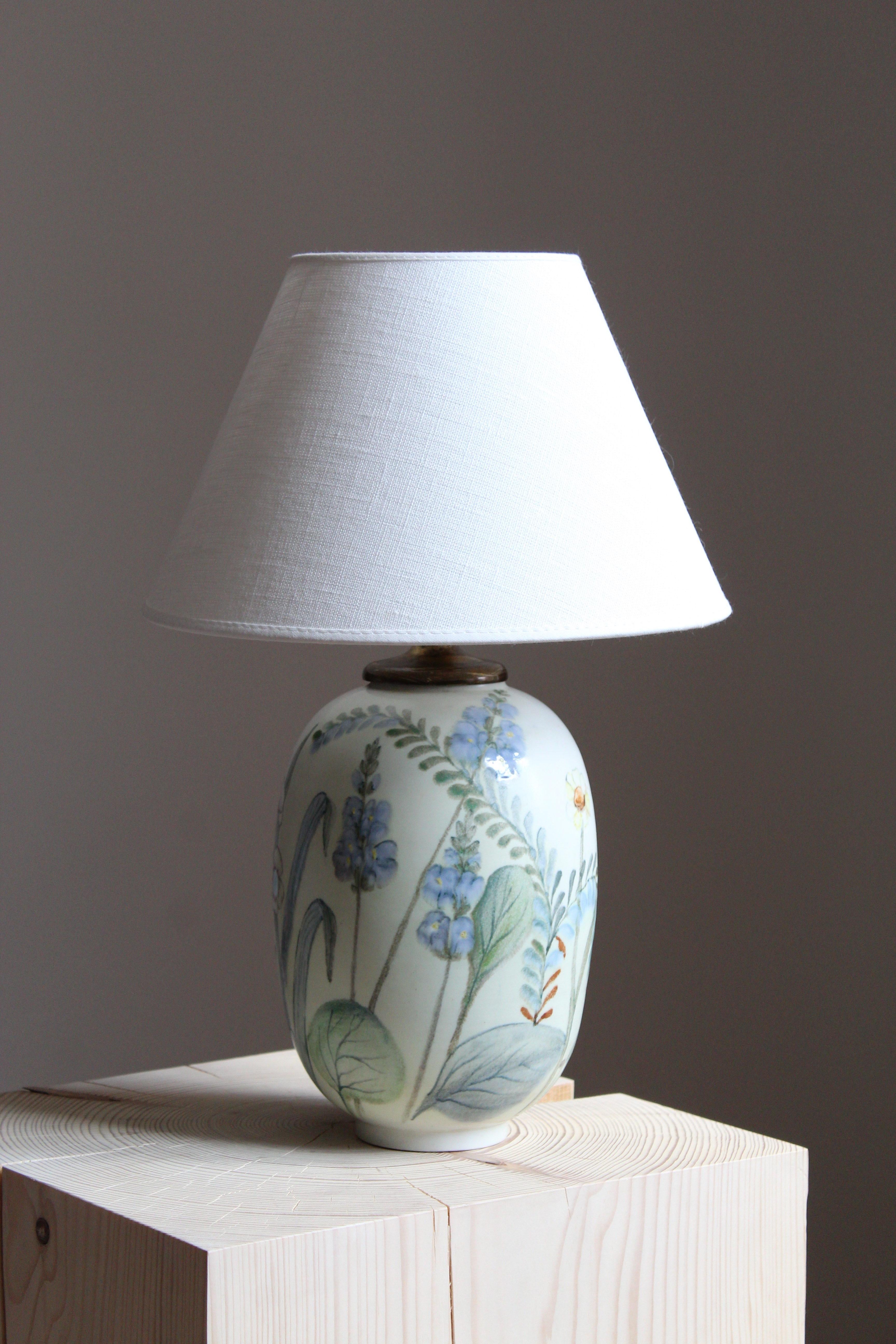 A rare and sizable table lamp by Carl-Harry Stålhane for the iconic Swedish firm Rörstrand. Features hand painted floral motifs, 1950s, Sweden. Marked.

Sold without lampshade. Stated dimensions excluding lampshade.

Glaze features green-blue-white