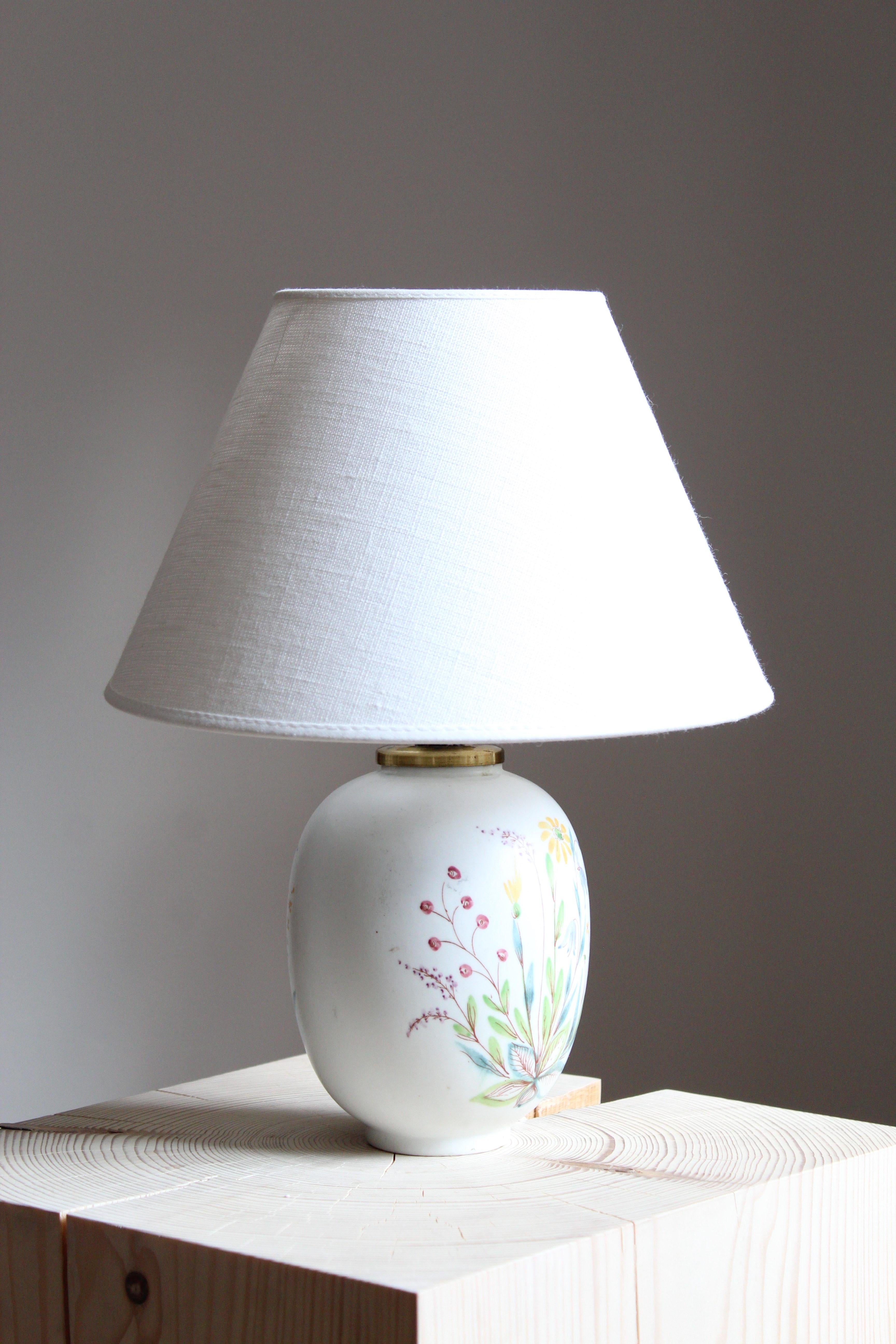 A rare and sizable table lamp by Carl-Harry Stålhane for the iconic Swedish firm Rörstrand. Features hand painted floral motifs, 1950s, Sweden. Marked. Stoneware or earthenware.

Sold without lampshade. Stated dimensions excluding