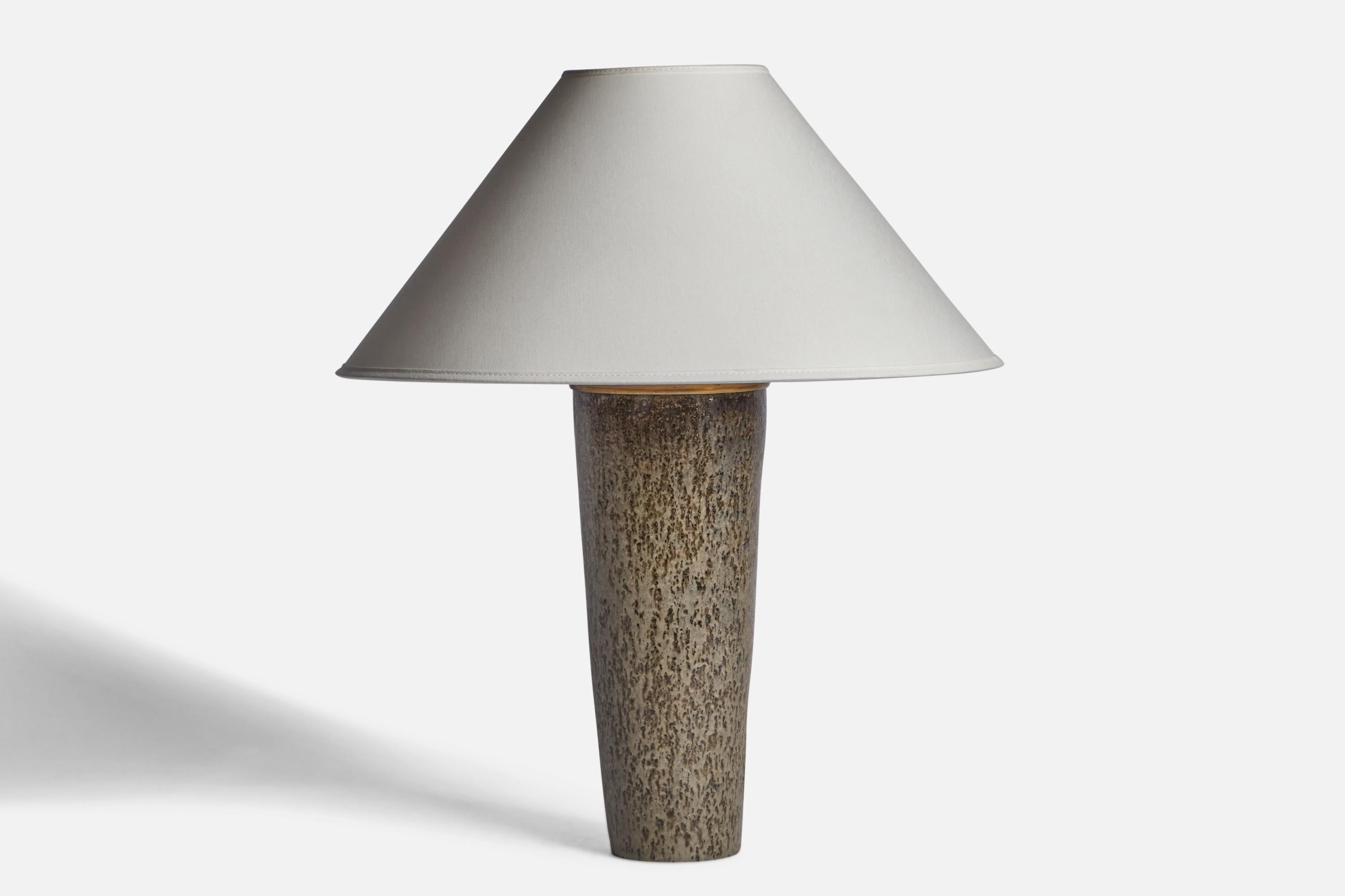 A grey-glazed stoneware and brass table lamp designed by Carl-Harry Stålhane and produced by Rörstrand, Sweden, 1950s.

Dimensions of Lamp (inches): 14.75” H x 5” Diameter
Dimensions of Shade (inches): 4.5” Top Diameter x 16” Bottom Diameter x 7.25”