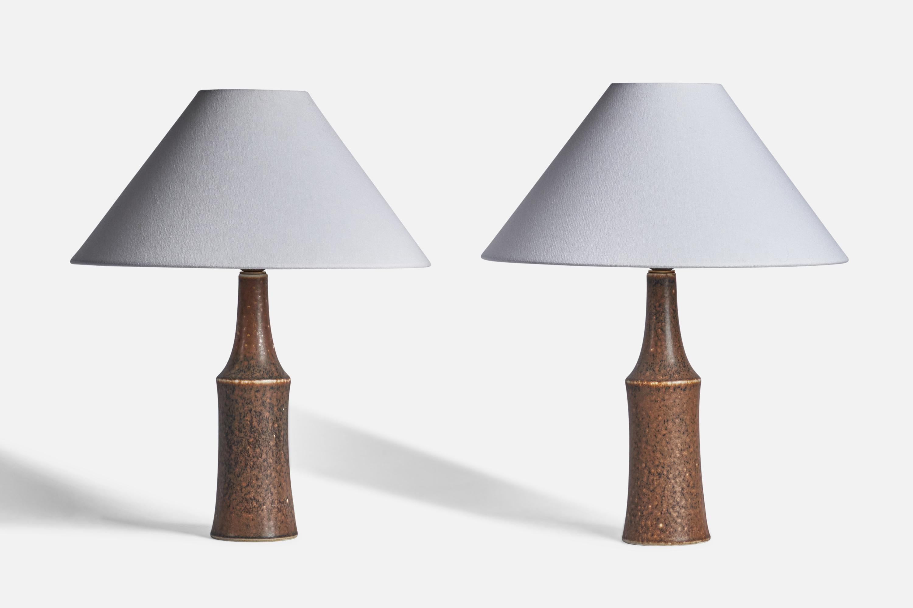 A pair of brown-glazed stoneware table lamps designed by Carl-Harry Stålhane and produced by Rörstrand, Sweden, 1950s.

Dimensions of Lamp (inches): 13.85 H x 3.80” Diameter
Dimensions of Shade (inches): 4.5” Top Diameter x 16” Bottom Diameter x