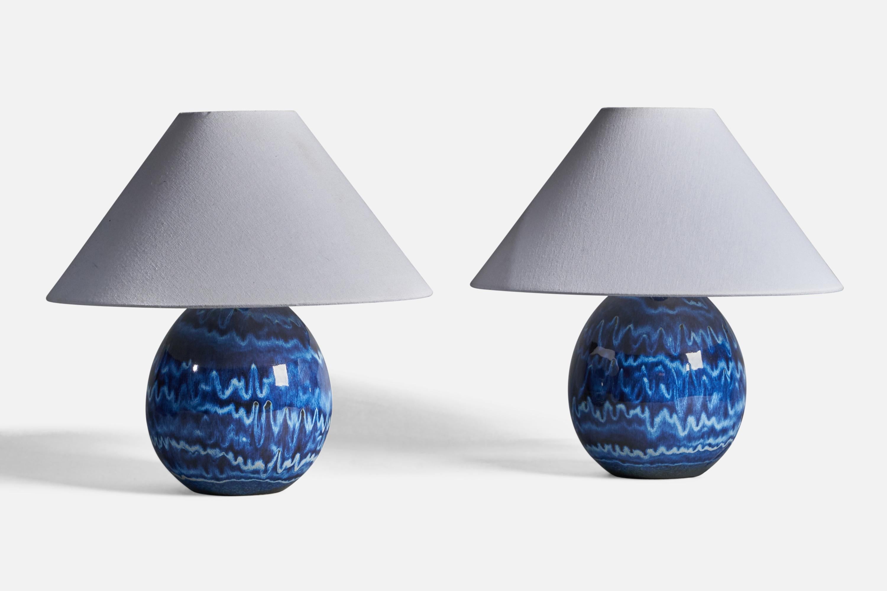 A pair of blue-glazed stoneware table lamps, designed by Carl-Harry Stålhane and produced by Designhuset, Sweden, c. 1970s.

Dimensions of Lamp (inches): 10.75