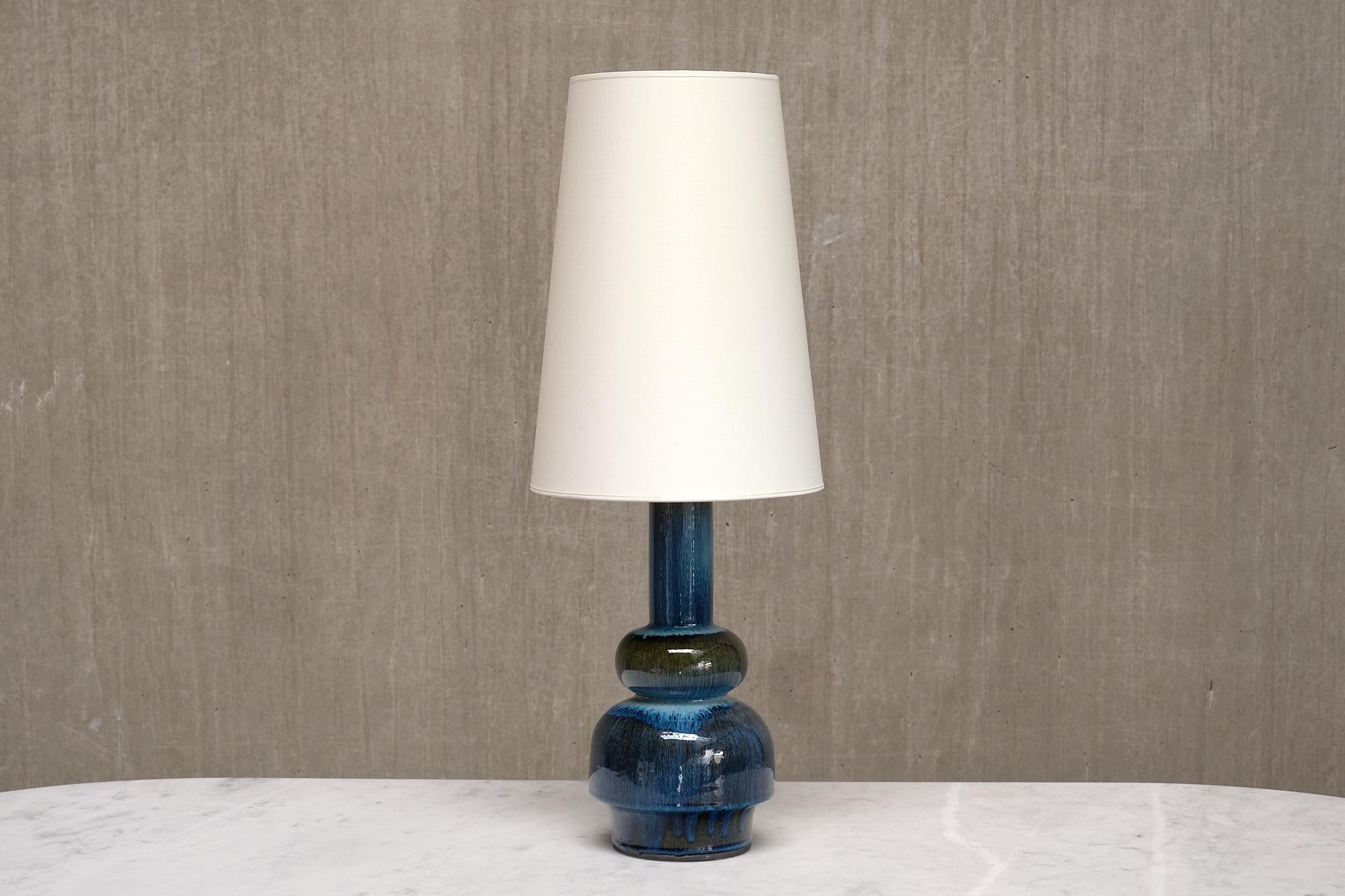 This rare, tall table lamp was designed by Carl-Harry Stålhane and produced by Rörstrand in the 1950s. The lamp is signed with the Rörstrand logo, “Sweden,” “CP32,” and the designer’s signature on the underside of the base.

The tall base, with its