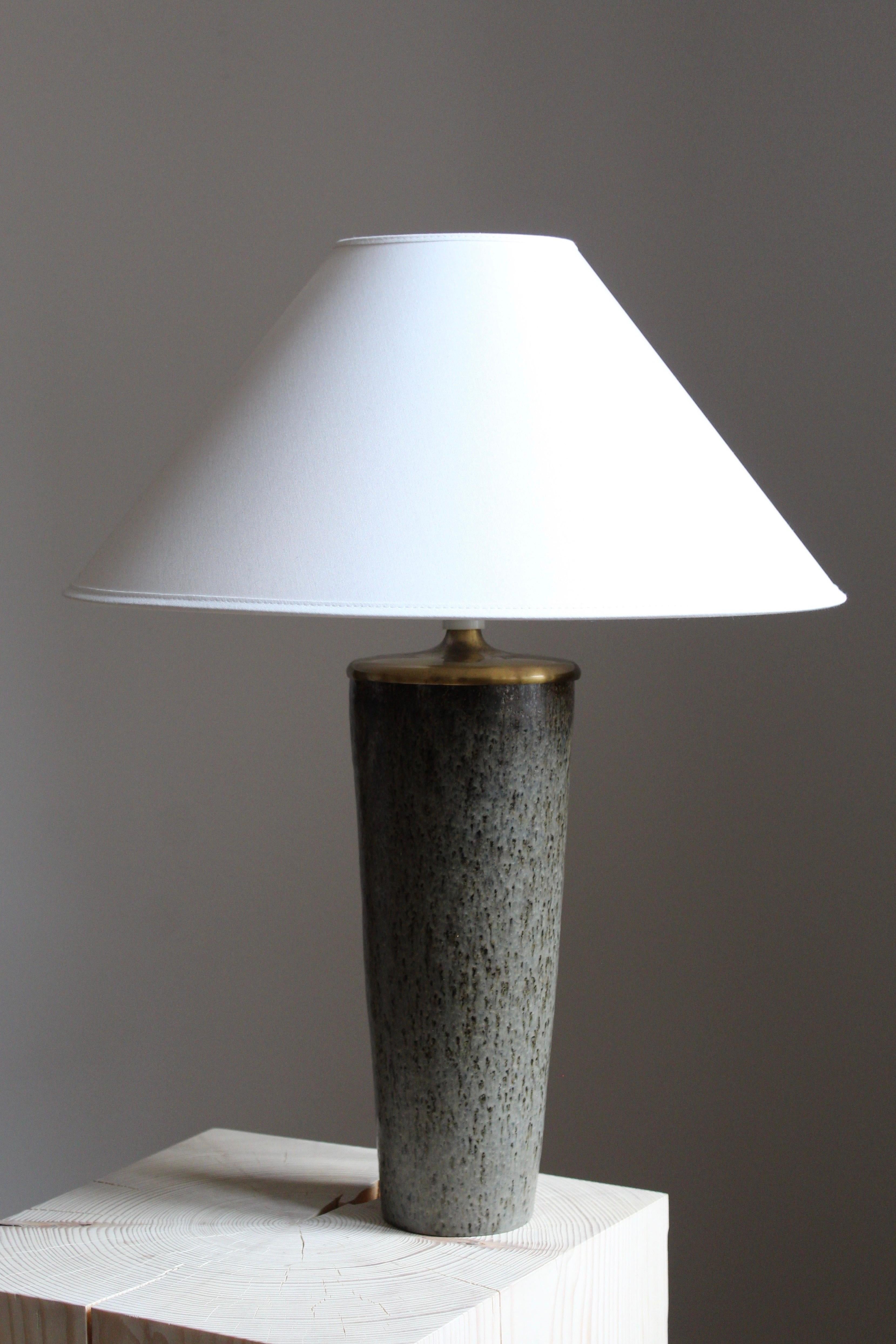 A sizable unique table lamp by Carl-Harry Stålhane for the iconic Swedish firm Rörstrand, 1950s, Sweden. Marked and signed.

Sold without a lampshade. Stated dimensions excluding lampshade.

Glaze features brown-grey colors.

Other ceramicists of