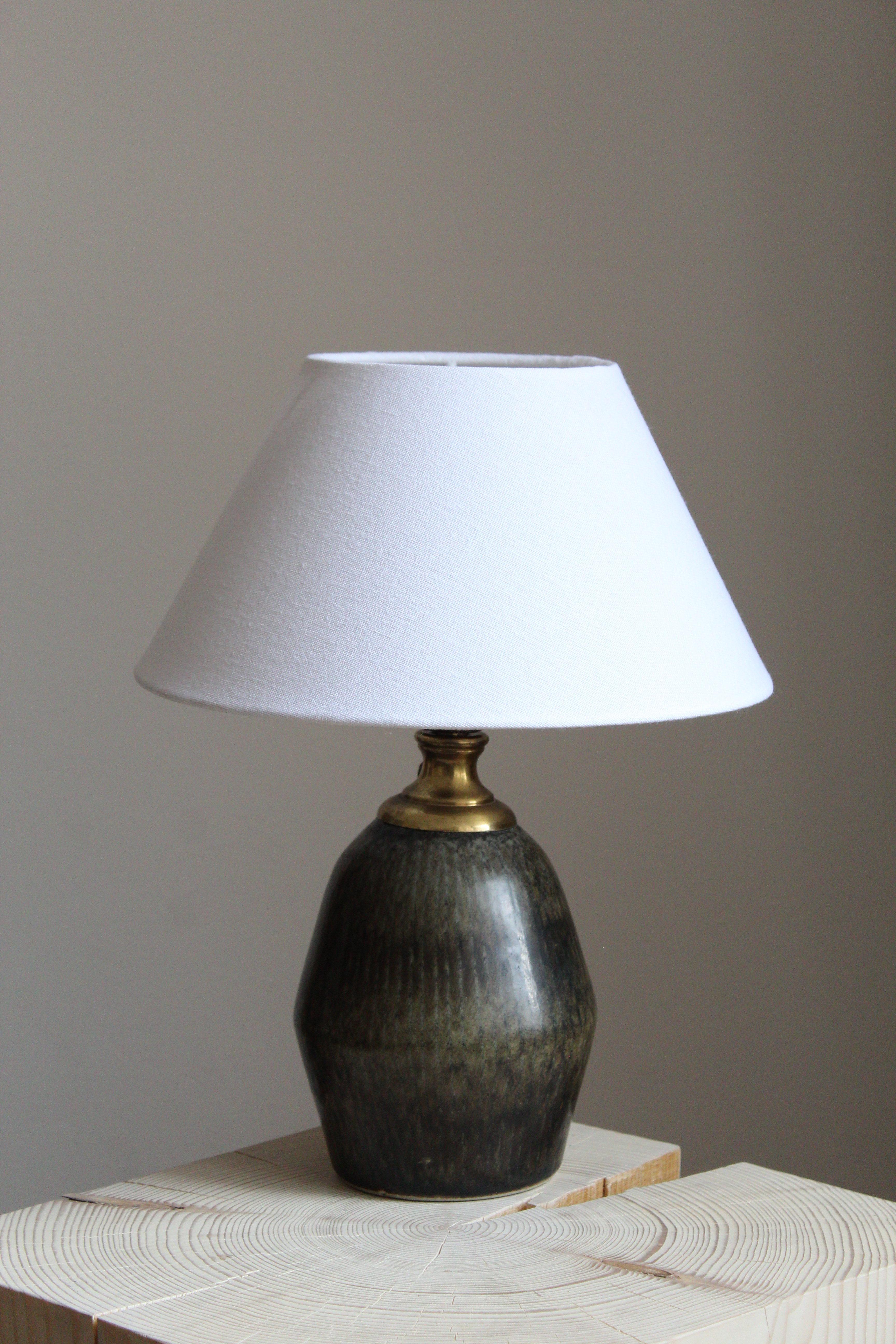 A unique table lamp by Carl-Harry Stålhane for the iconic Swedish firm Rörstrand. Signed

Stated dimensions exclude lampshade. Height includes the socket. Sold without lampshade.

Glaze features brown-green colors.

Other ceramicists of the period