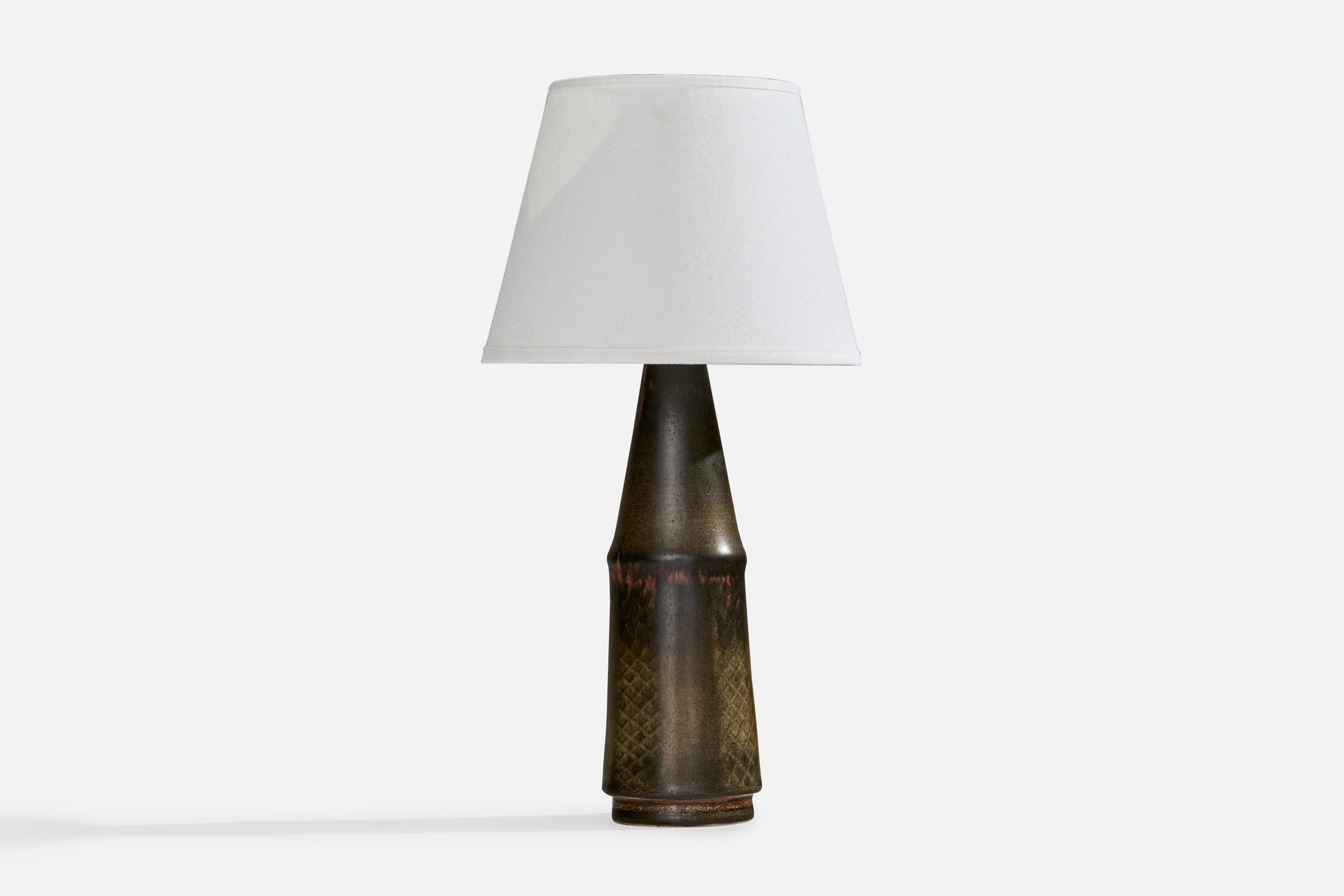 A unique grey-glazed and incised table lamp designed by Carl-Harry Stålhane and produced by Rörstrand, Sweden, 1950s.

Dimensions of Lamp (inches): 13” H x 3.45”  Diameter
Dimensions of Shade (inches): 5.5”  Top Diameter x 7.75”  Bottom Diameter x