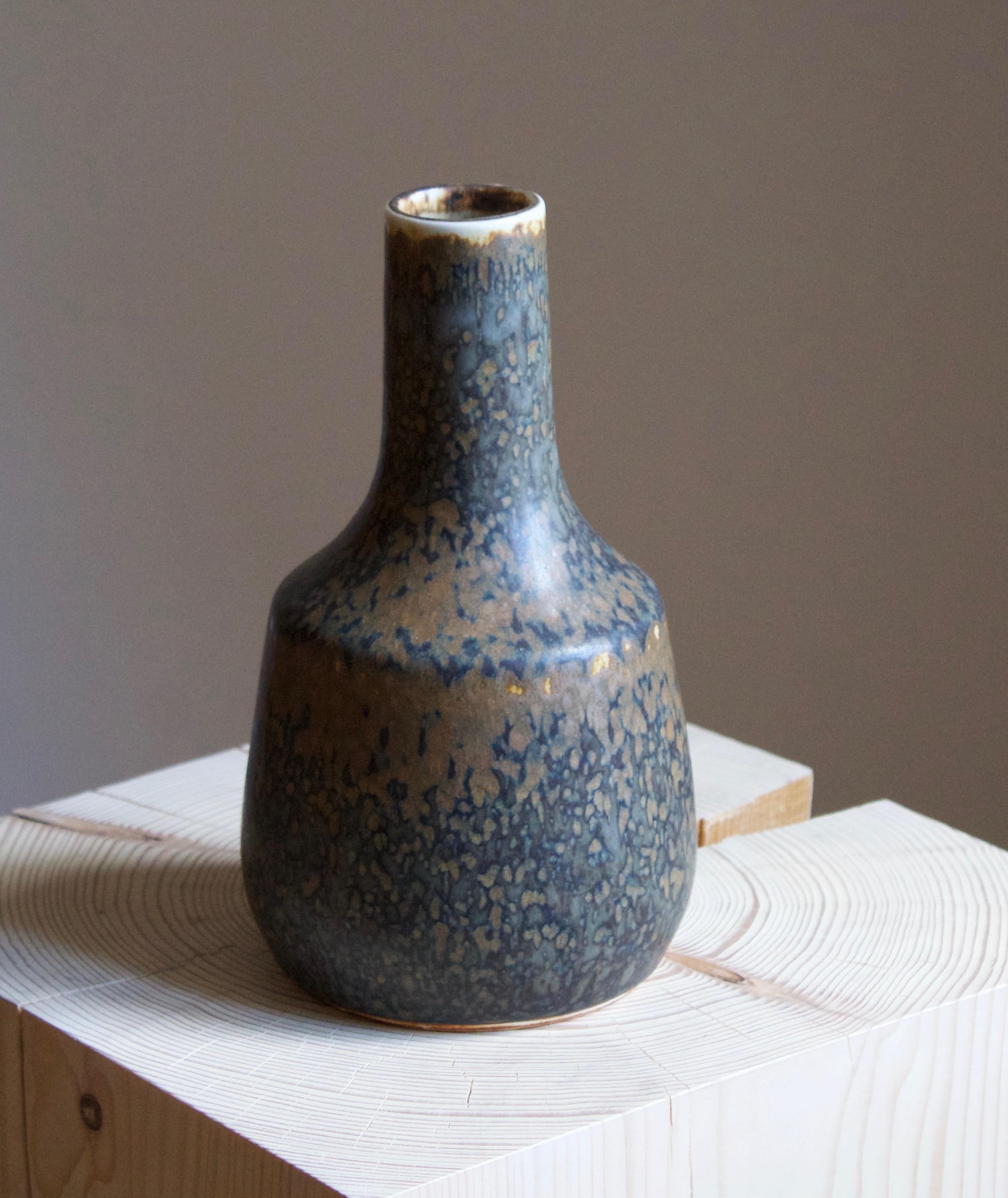 A stoneware vase or vessel designed by Carl-Harry Stålhane produced by Rörstrand, signed, likely produced 1960s. 

Other designers of the period include Axel Salto, Hans Cooper, Wilhelm Kåge, and Lucie Rie.