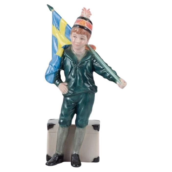 Carl Larsson Pontus for Royal Copenhagen, Porcelain Figure, Standard-Bearer Boy For Sale