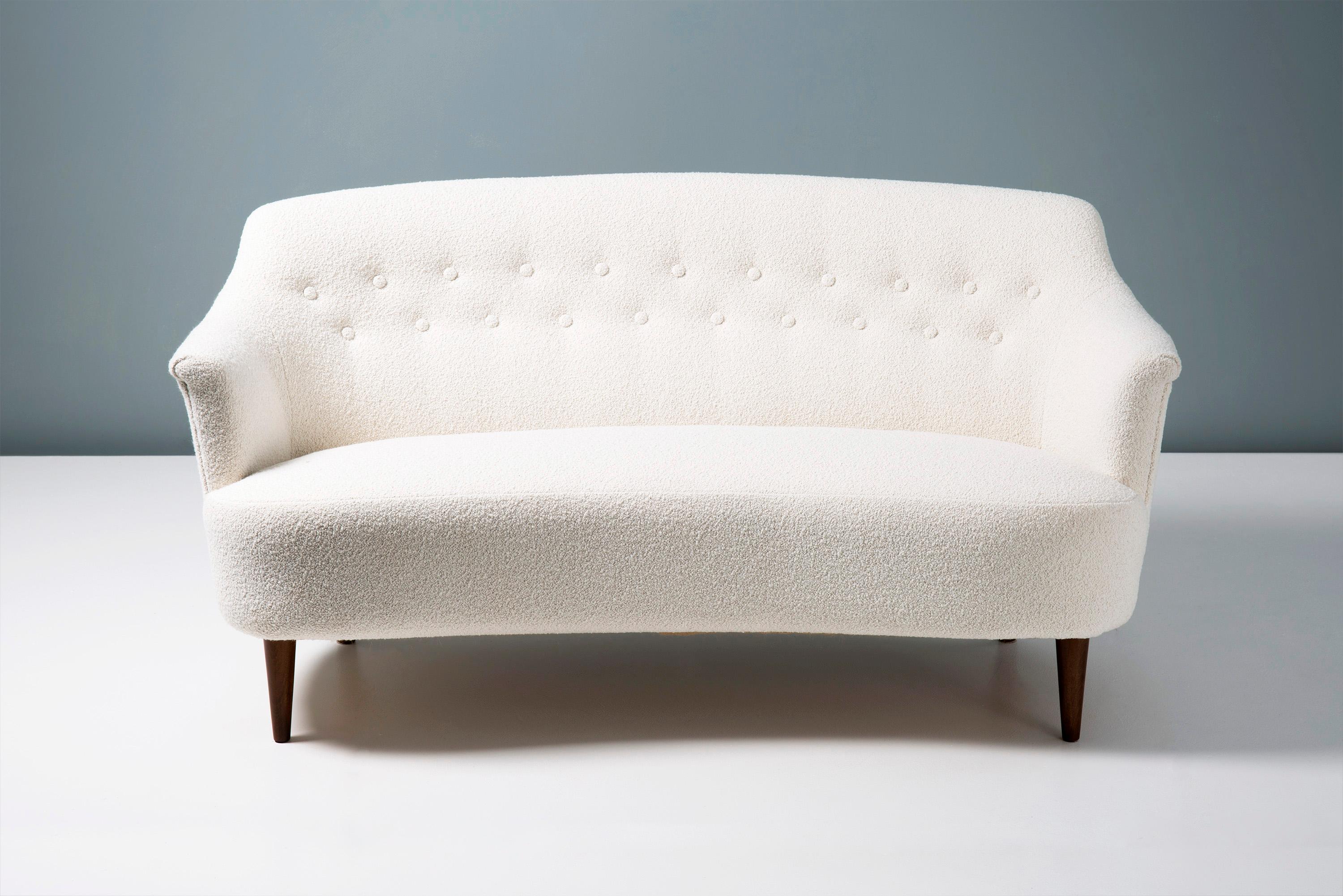 This exceptional piece of Swedish furniture was designed in the 1940s by master cabinetmaker & designer Carl Malmsten. It was produced at his own workshop near Stockholm in Sweden. This example has been reupholstered in luxurious cotton-wool blend