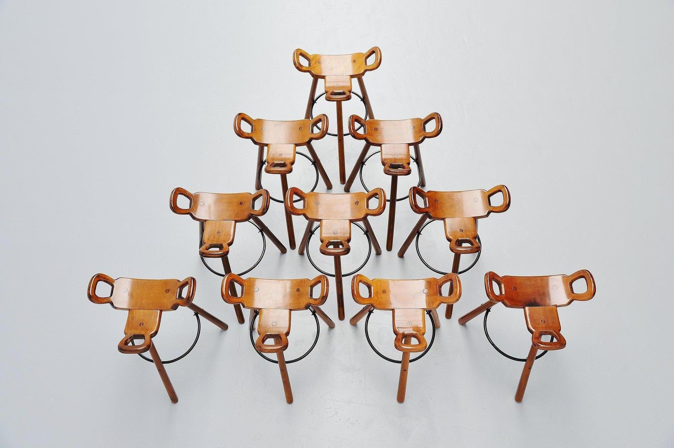 Very nice and large set of 10 bar stools designed by Carl Malmsten, Sweden 1950. These stools are very nicely shaped and made of solid birch wood, dark stained. The stools have a black metal supporting footrest ring. These stools are in original