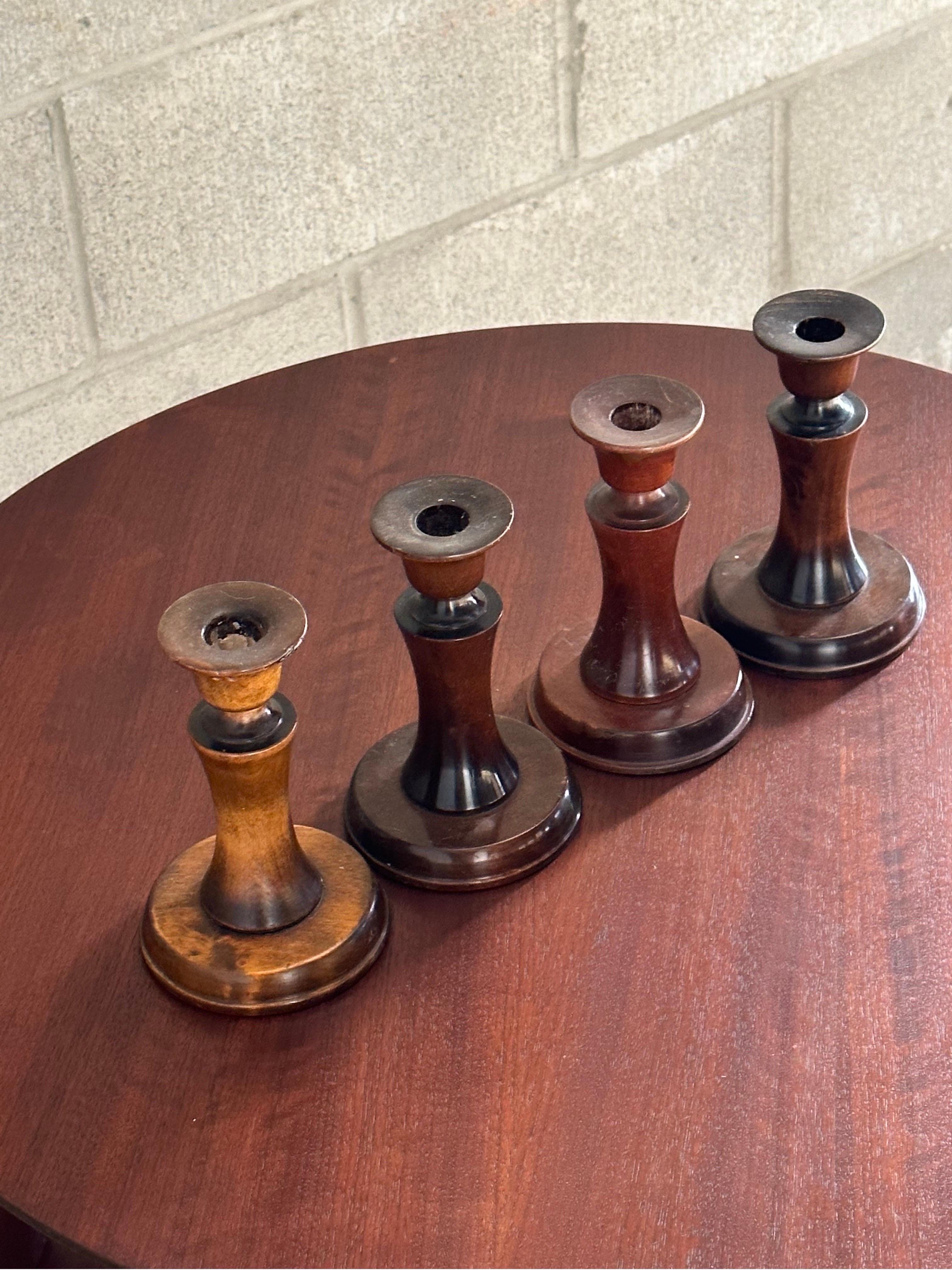 Rare set of four candle holders designed by Carl Malmsten. Has an elegant swedish craftsman feel to them. These have been used and show signs of such. All are marked on bottom