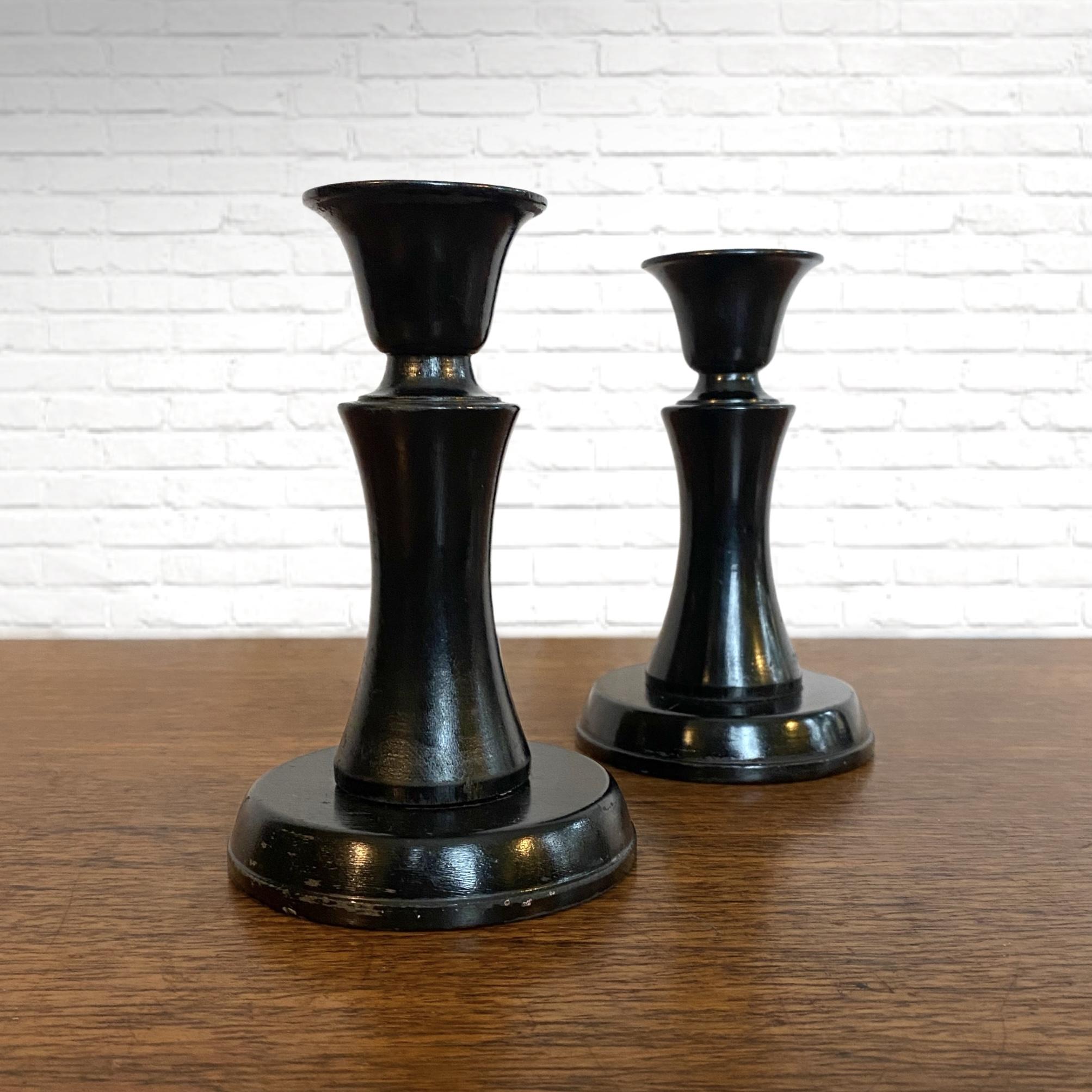 A matching pair of candlesticks number 11, designed by Carl Malmsten in 1927 for Liljeholmens Stearinfabrik. Black painted birch. Malmsten designed a series of candlesticks for the stearine candle manufacturer during a challenging economic period