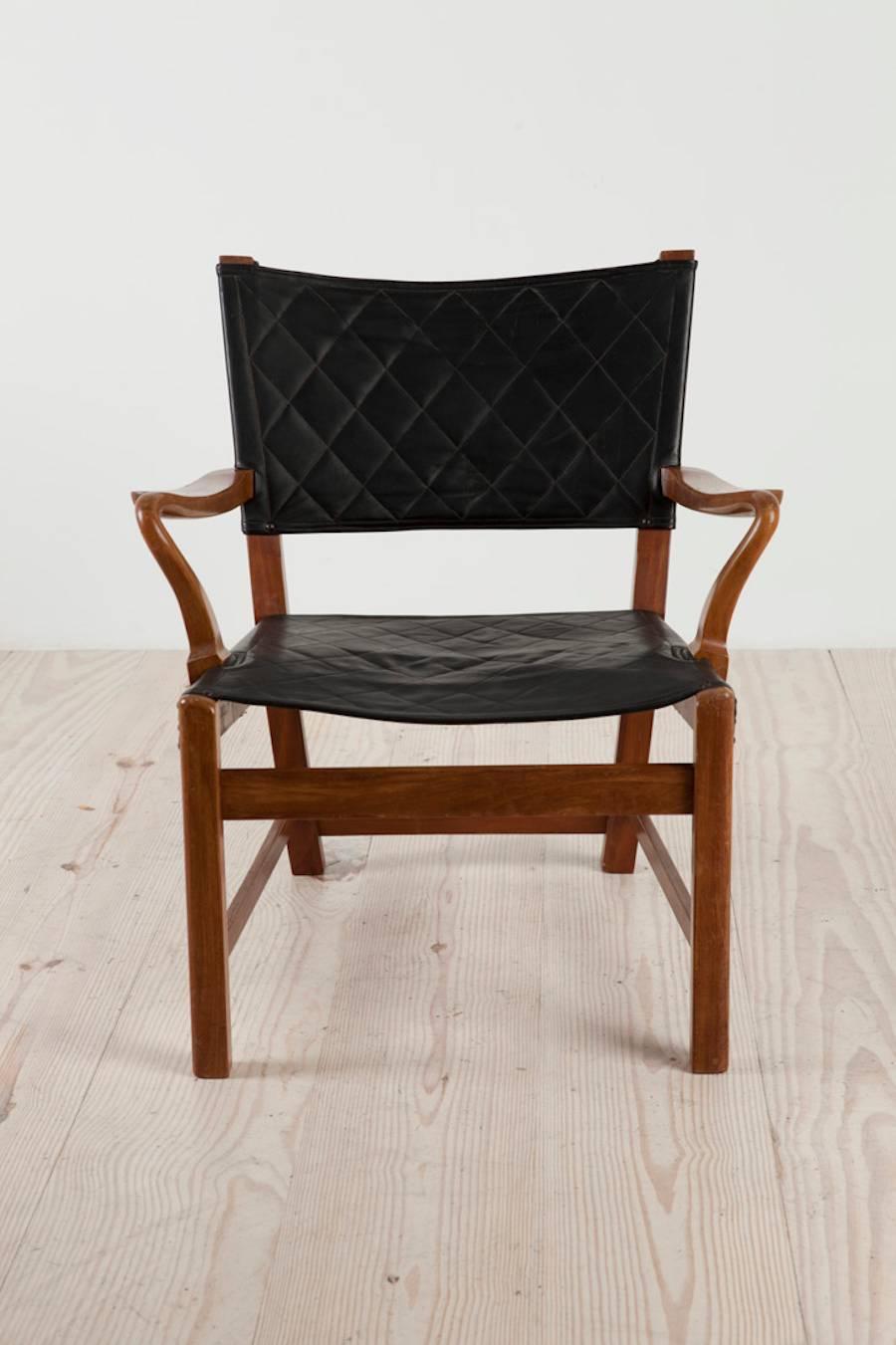 Carl Malmsten (1889 Sweden 1972), easy chair, circa 1929, in stained birch with open arms, in original quilted black leather applied to frame with nail heads, origin: Sweden.

Reference: Carl Malmsten, by Anna Greta Wahlberg, Sweden; Bokförlaget