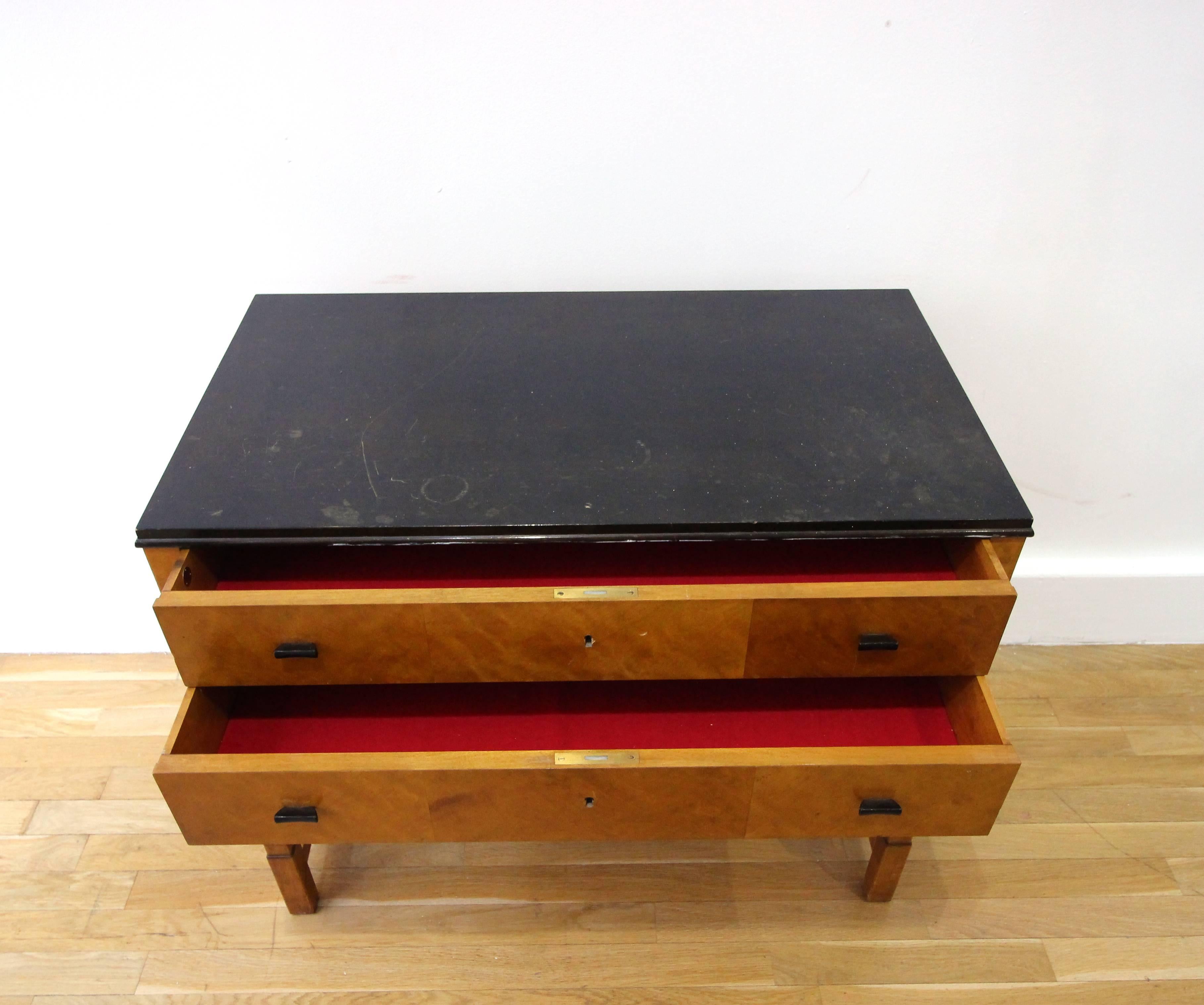 Sideboard from the collection “Haga”. Design by Carl Malmsten for Nordiska Kompaniet, 1920s. Made in birch with intarsia decorations, black lower part. Dimensions: Height 75, width 91x depth 51 cm. Supplied with the key.