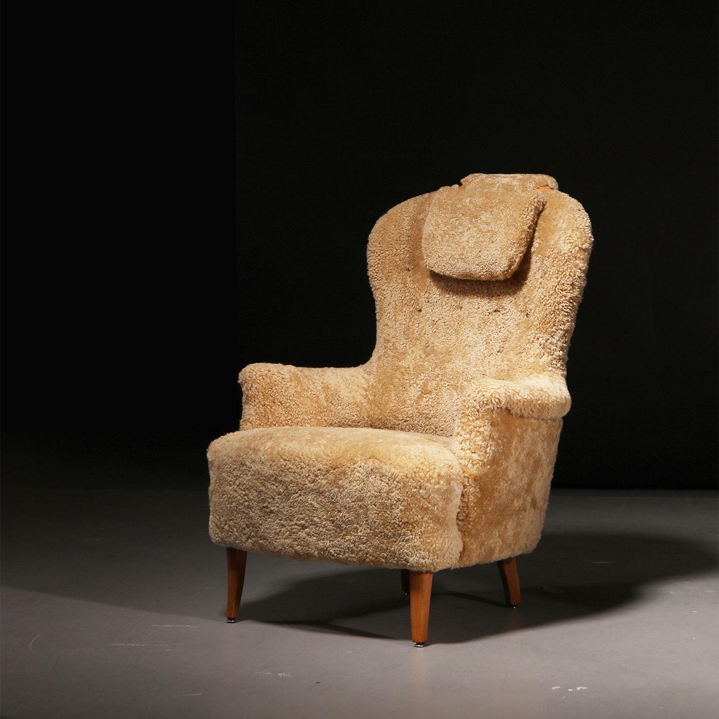 Armchair model 'Farmor', designed by Swedish designer Carl Malmsten (1888–1972). Manufactured by O.H. Sjögren in the 1950s. Wooden legs, armchair recently reupholstered in Honey sheepskin.

The iconic 'Farmor' (or 'Grandmother') armchair, designed