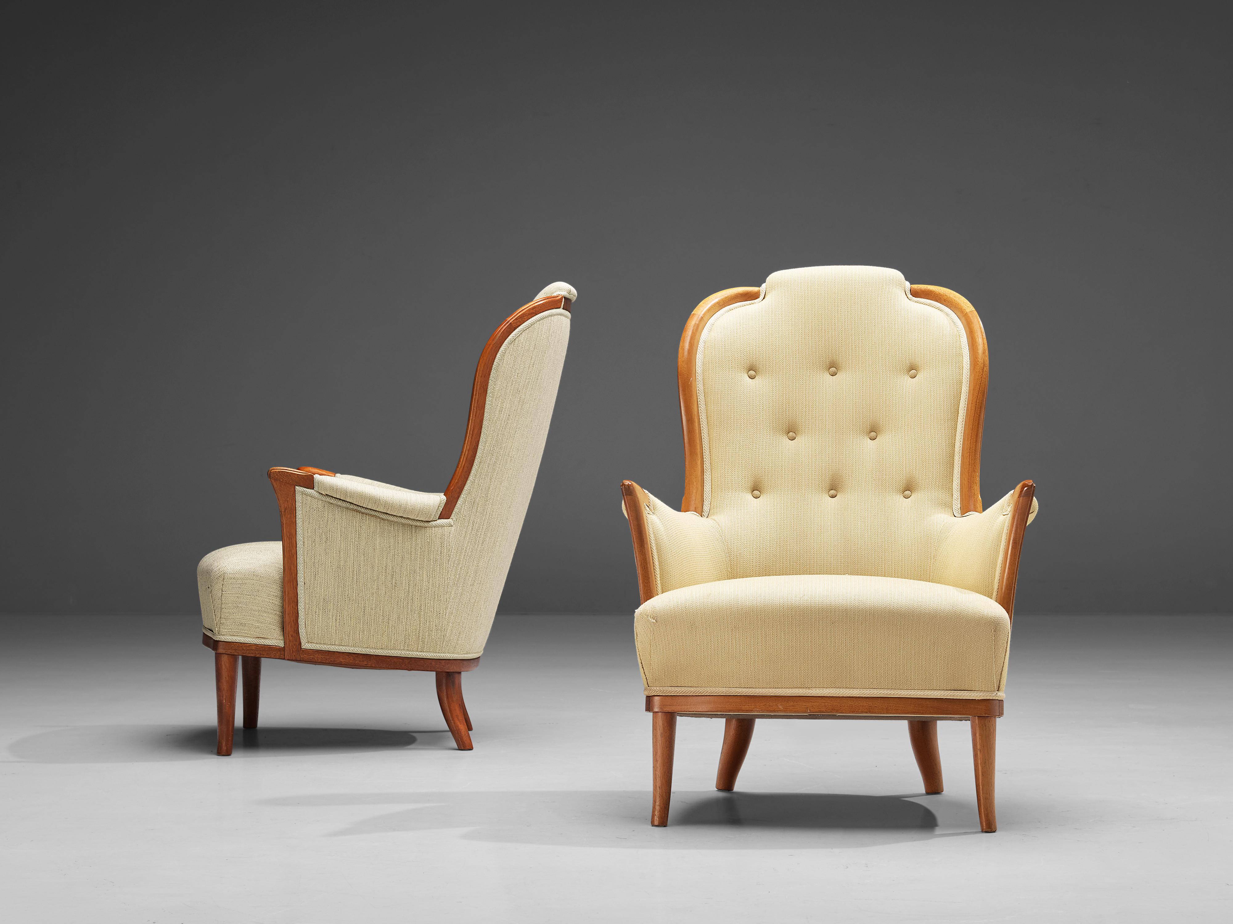 Carl Malmsten for O.H. Sjögren, 'Our Lady' pair of lounge chairs, teak, fabric, Sweden, 1950s. 

Very interesting pair of Swedish lounge chairs by Carl Malmsten in off-white and pastel yellow fabric with tufted back. The distinctive lines and