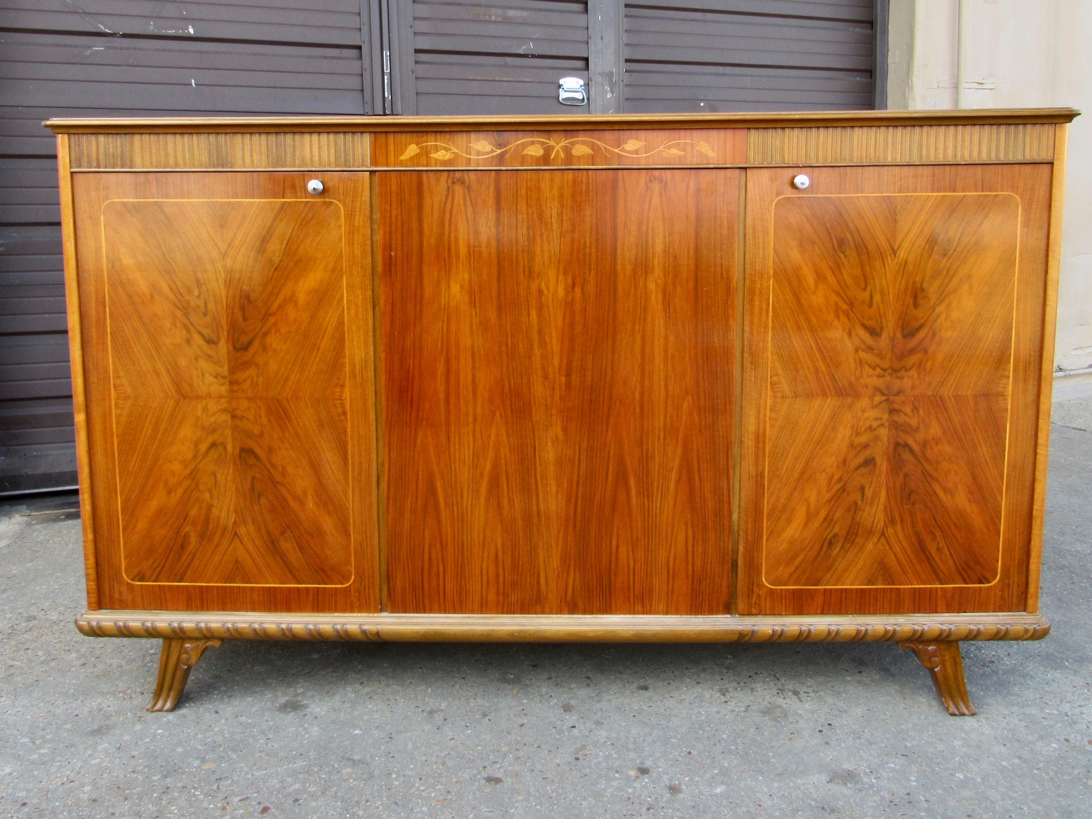Carl Malmsten for Svenska Mobelfabriken cabinet/sideboard in walnut circa 1950.
With original shelves (see them sitting in bottom of photos inside cabinet) are removable and adjustable. The cabinet has been lightly restored and is in excellent