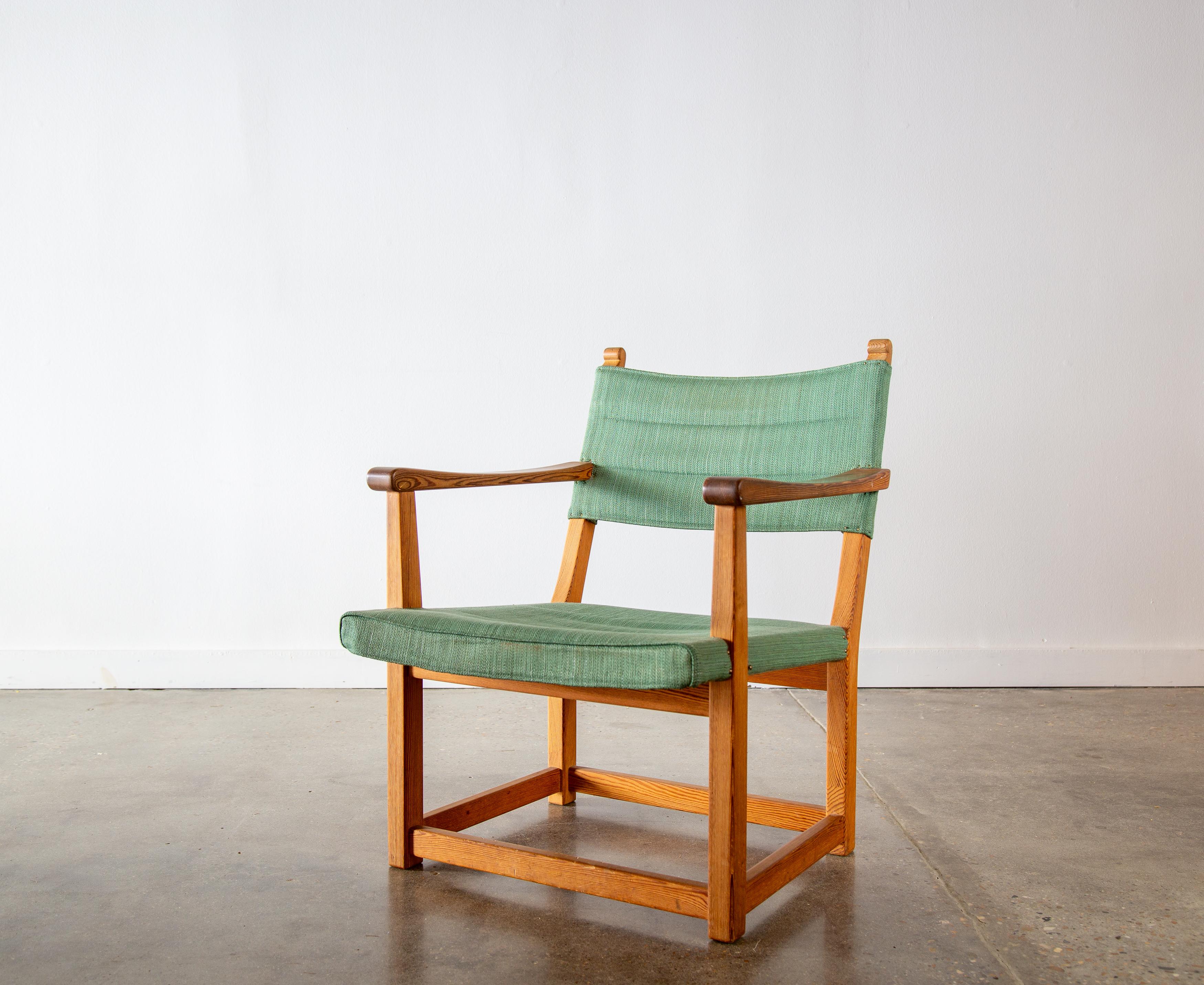 An exceedingly rare chair designed by Carl Malmsten.  The “hangsits” armchair, c. 1947 in solid pine and original green fabric.  From Sweden these chairs weren’t offered as knock down furniture that was shippable so to find any in America is rare. 