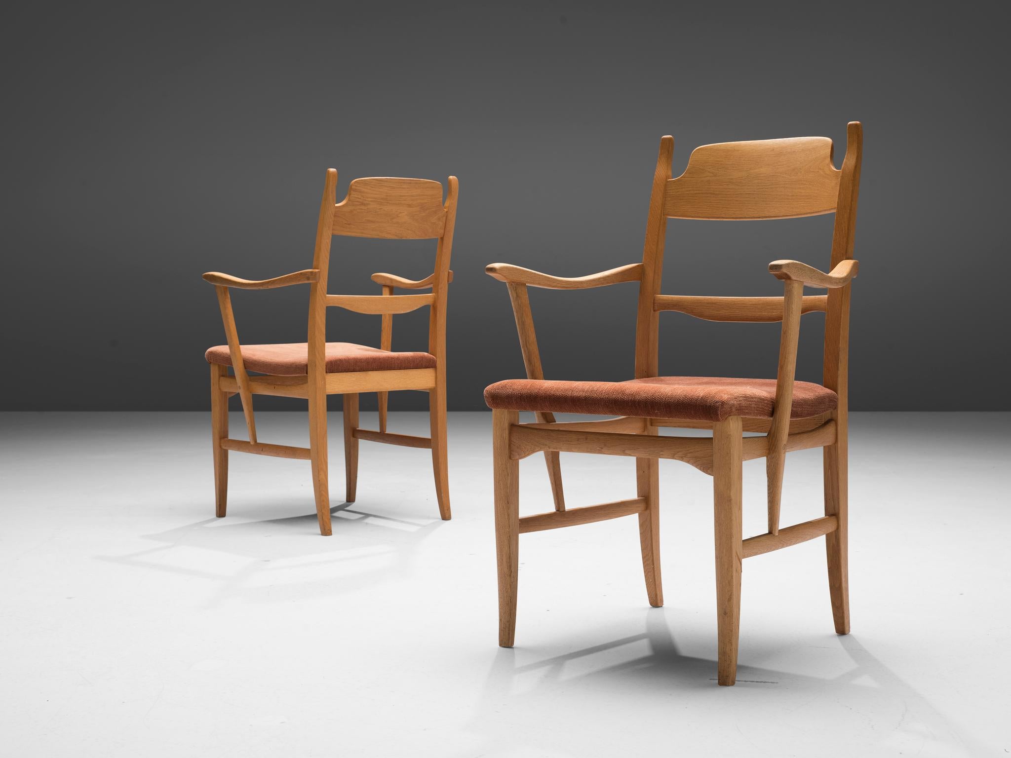 Carl Malmsten, pair of armchairs, oak, fabric, Sweden, 1940s 

This pair of armchairs is designed by Swedish designer Carl Malmsten (1888-1972). The shape of the lines are striking and the tapered wooden legs complement its shape beautifully. The