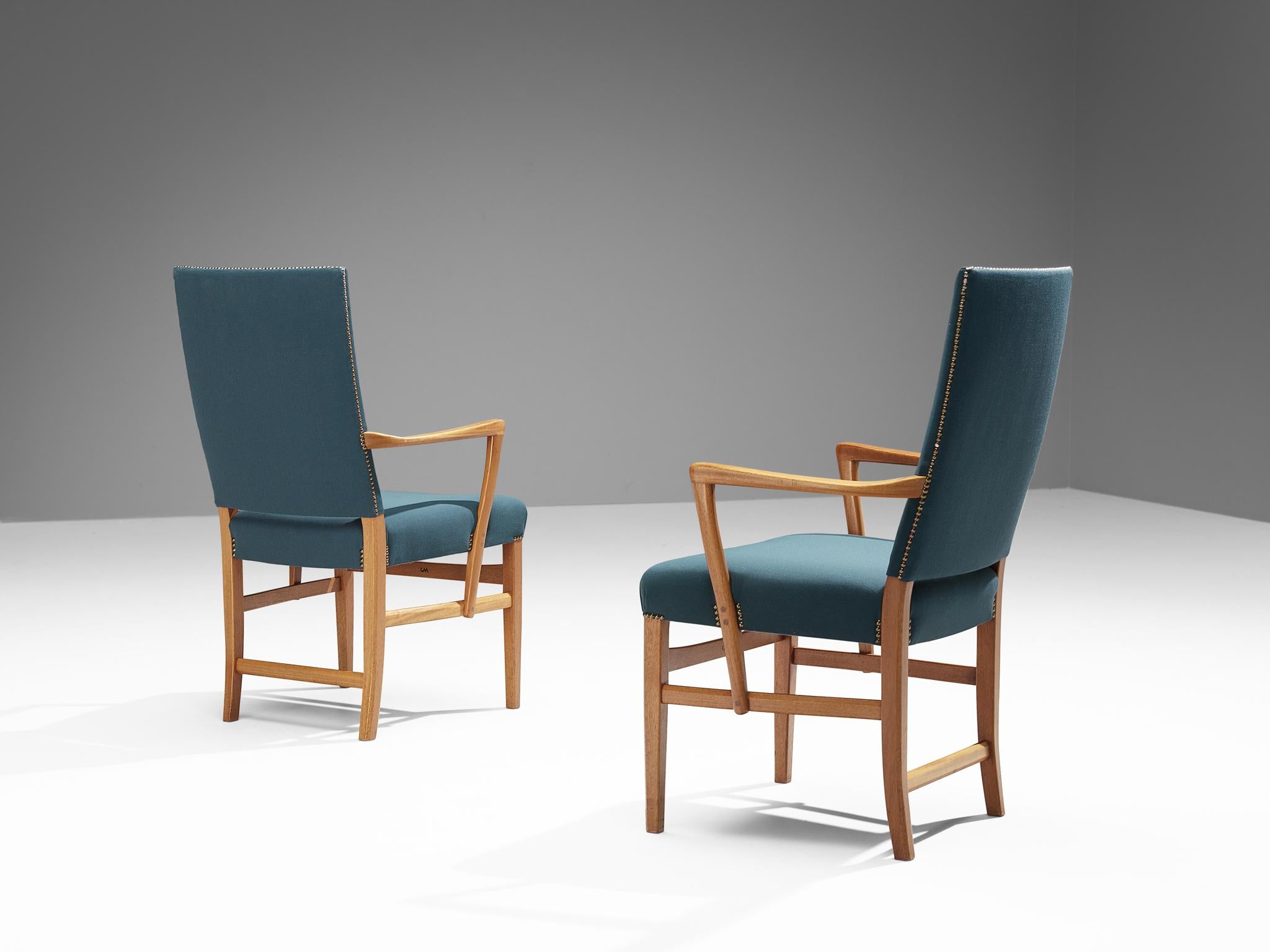 Carl Malmsten, pair of dining chairs, teak, fabric, brass, Sweden, circa 1970

These high back armchairs are designed by the Swedish designer Carl Malmsten (1888-1972). These elegant armchairs are a prime example of Scandinavian Modern design