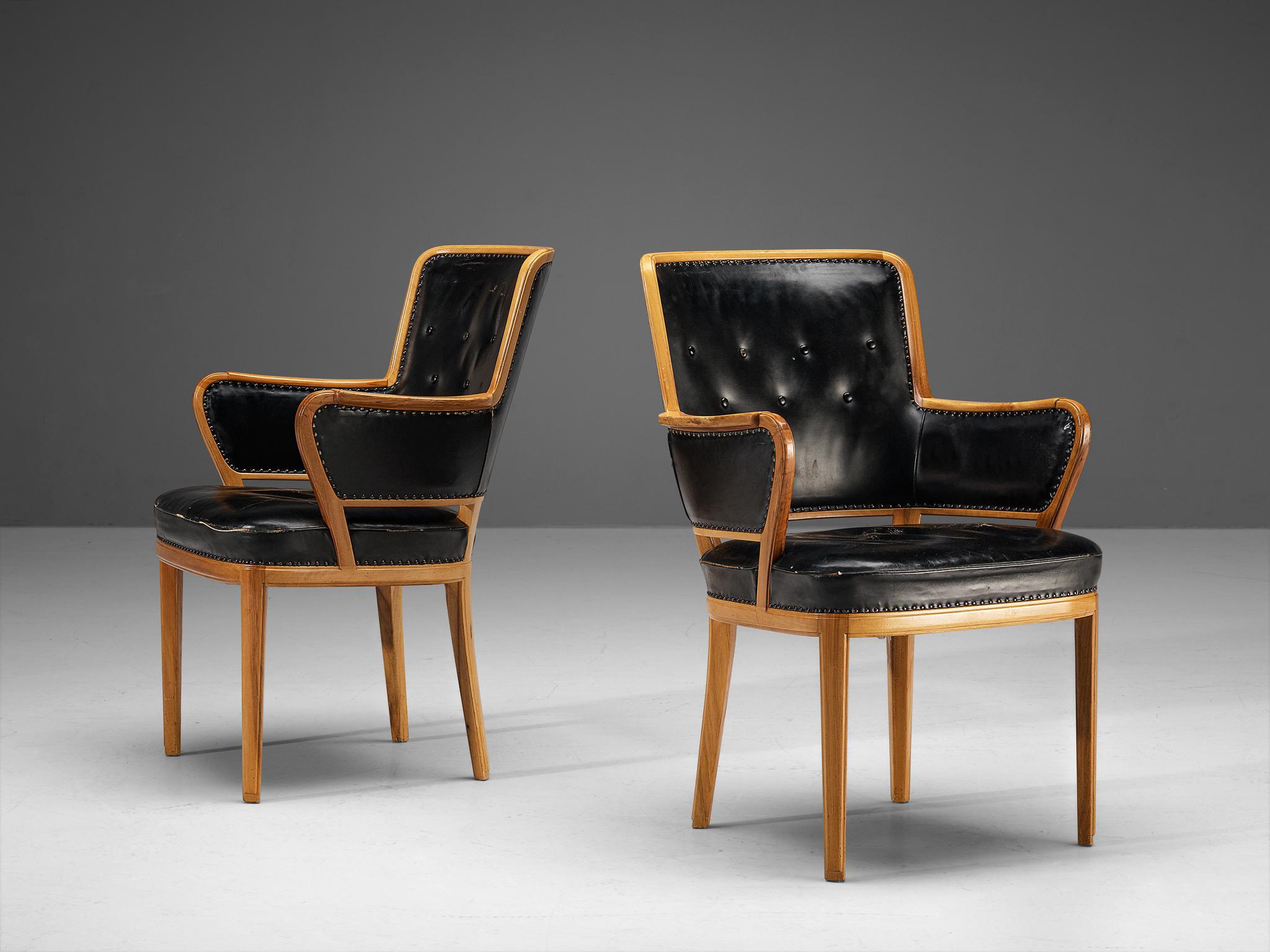 Carl Malmsten, pair of armchairs, walnut, leather, Sweden, 1940s. 

Rare pair of armchairs designed by Swedish designer Carl Malmsten. These chairs contain a warm walnut frame which is nicely visible, and the grain pattern comes out beautifully as