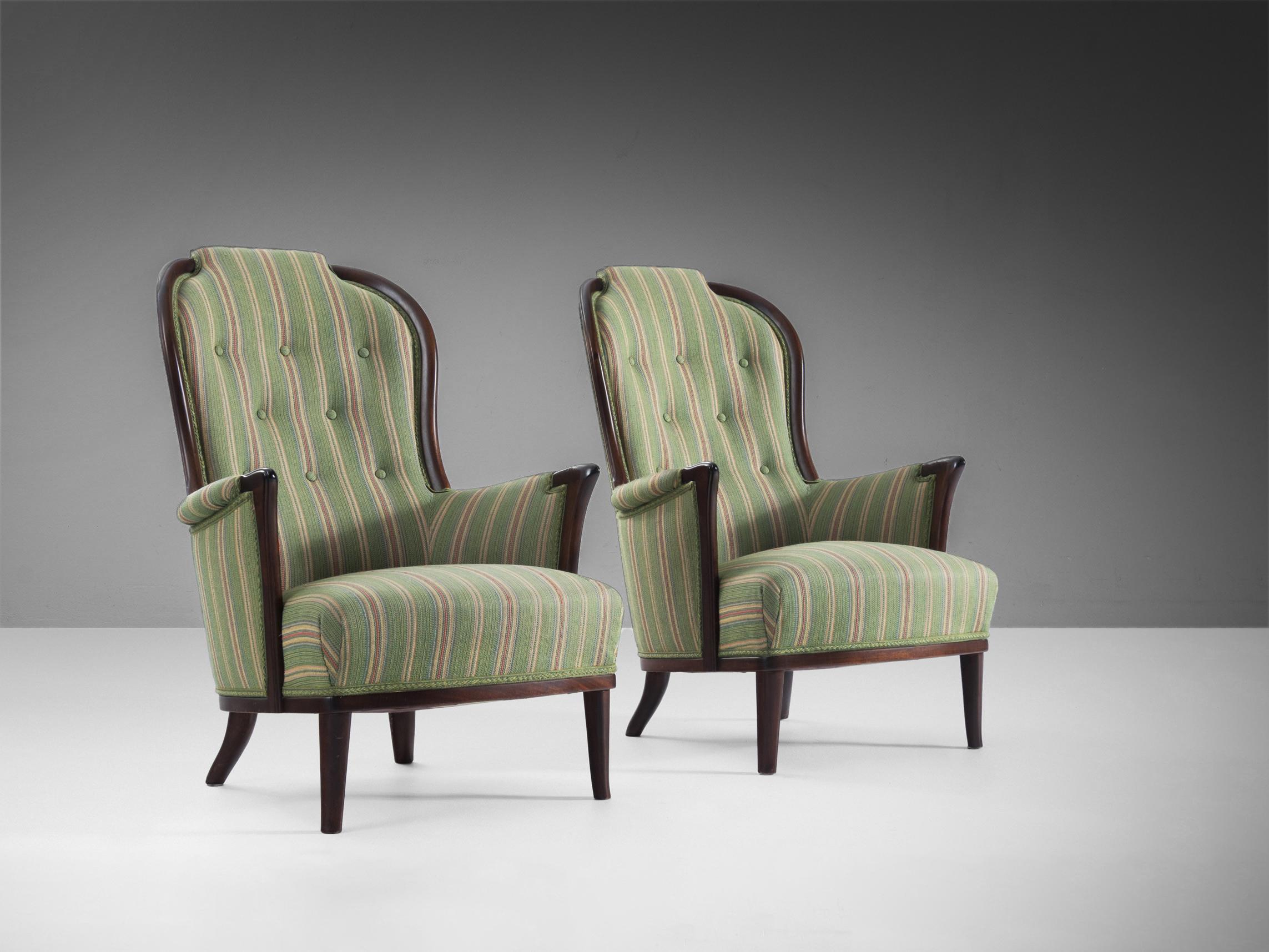 Carl Malmsten, pair of easy chairs, fabric, wood, Sweden, 1960s.

Pair of wonderful chairs that are very well designed by Carl Malmsten. The armchairs are upholstered in the original fabric mainly in the color green adorned with colorful stripes.