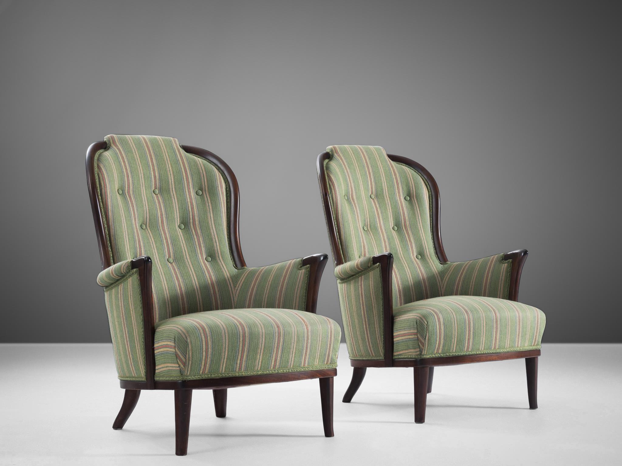 Carl Malmsten, pair of easy chairs, fabric, wood, Sweden, 1960s.

Pair of wonderful chairs that are very well designed by Carl Malmsten. The armchairs are upholstered in the original fabric mainly in the color green adorned with colorful stripes.