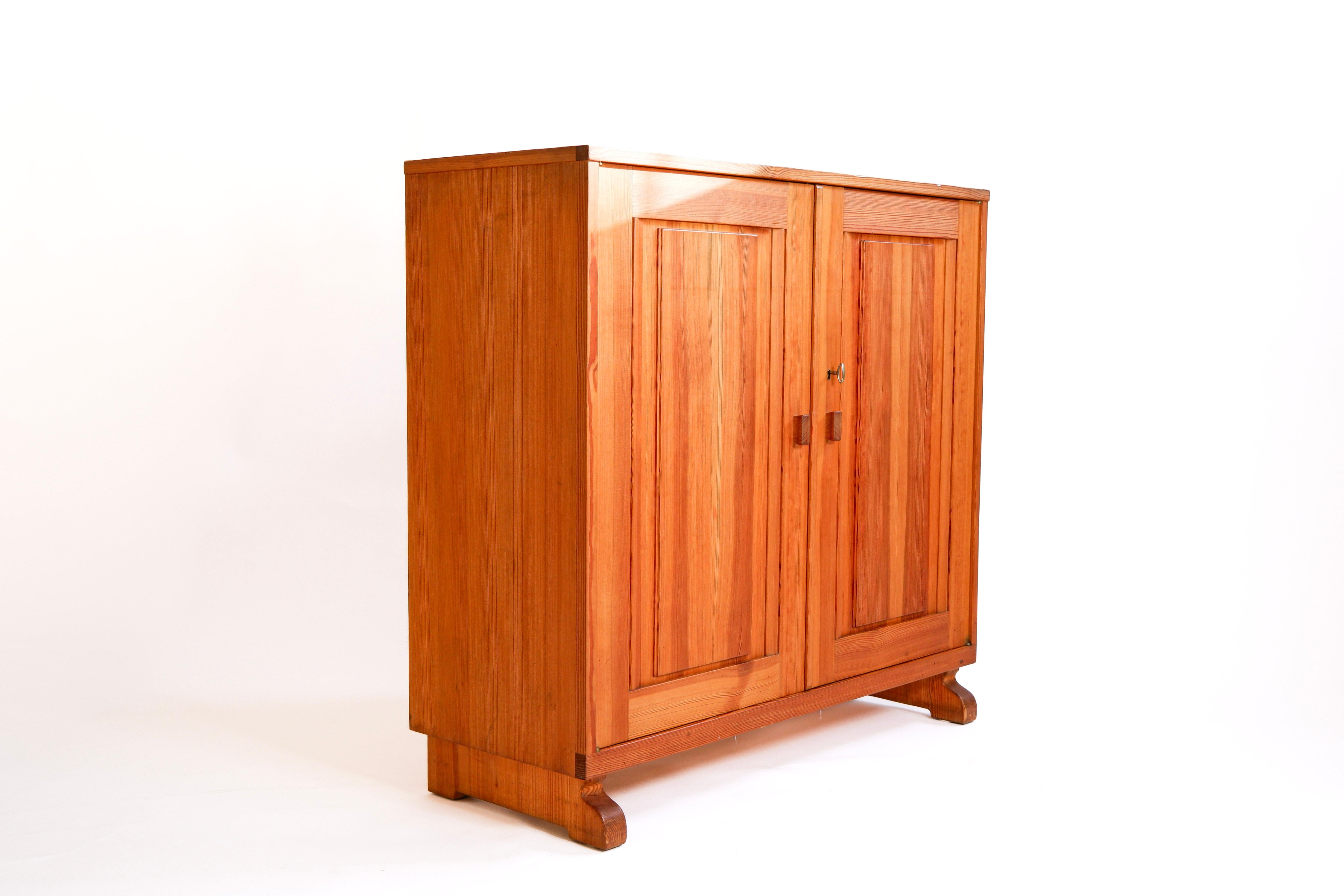 Pine Cabinet designed and produced by Carl Malmsten in Sweden in the 50's. The cabinet is made in solid pine, two drawers inside. Good overhall condition. The cabinet is marked by the artist. Carl Malsten is one of the leading designer of the 