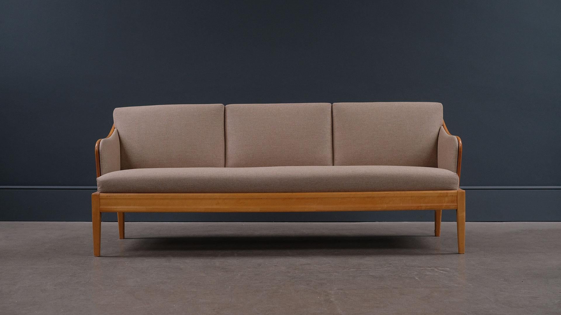 Super elegant sofa designed by Carl Malmsten, 1940s, Sweden. Lovely Birch wood frame with nice grain and warm patina. Fully refurbished and reupholstered seats. Comfortable sofa and fully sprung mattress make it useable as a daybed.