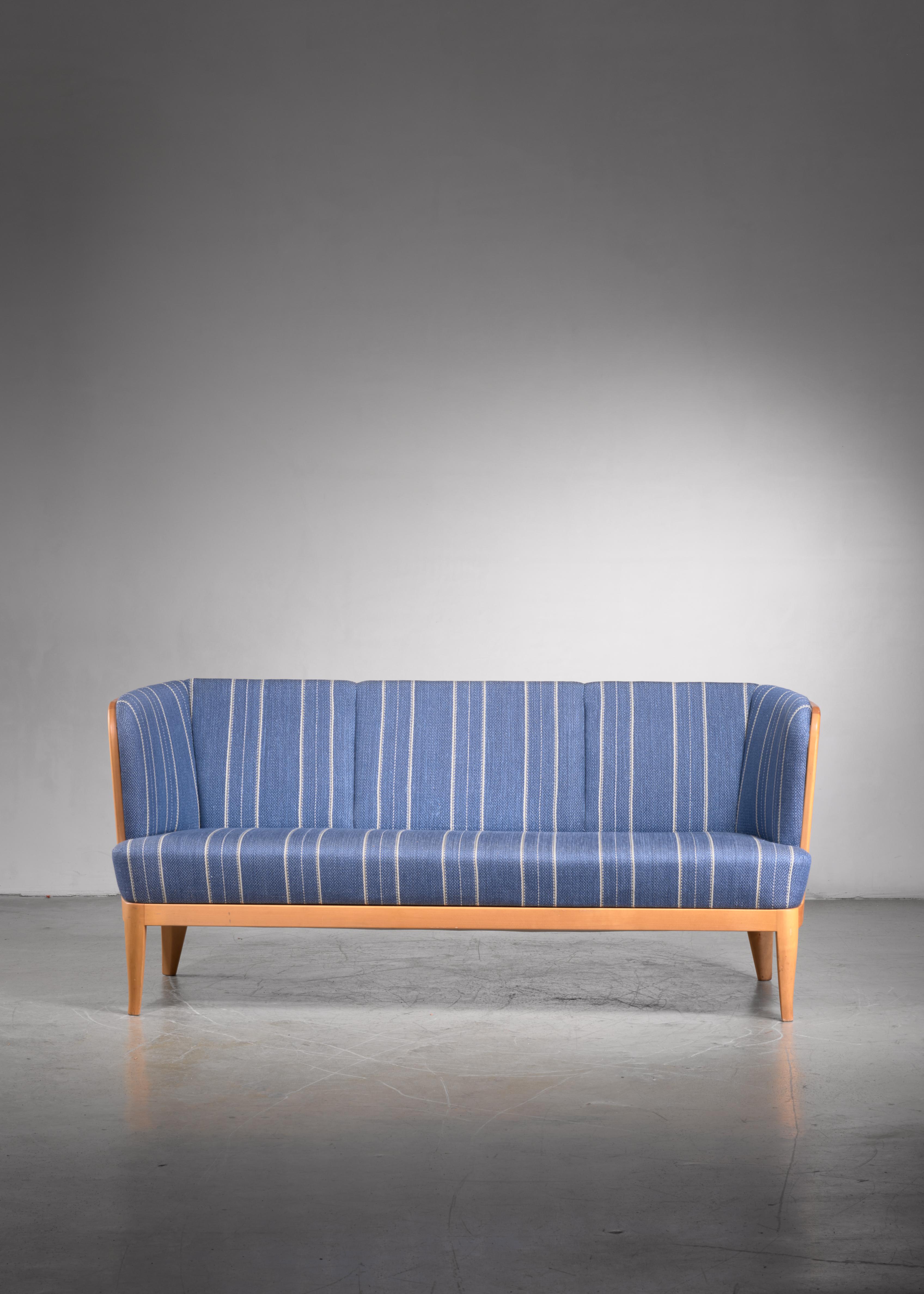 A wonderful three-seater model 'Ulla' sofa by Carl Malmsten. The sofa is made of an elegant birch frame with fixed cushions, upholstered with a wool and cotton fabric in blue and white stripes.

The sofa was designed in 1938 for an exhibition in