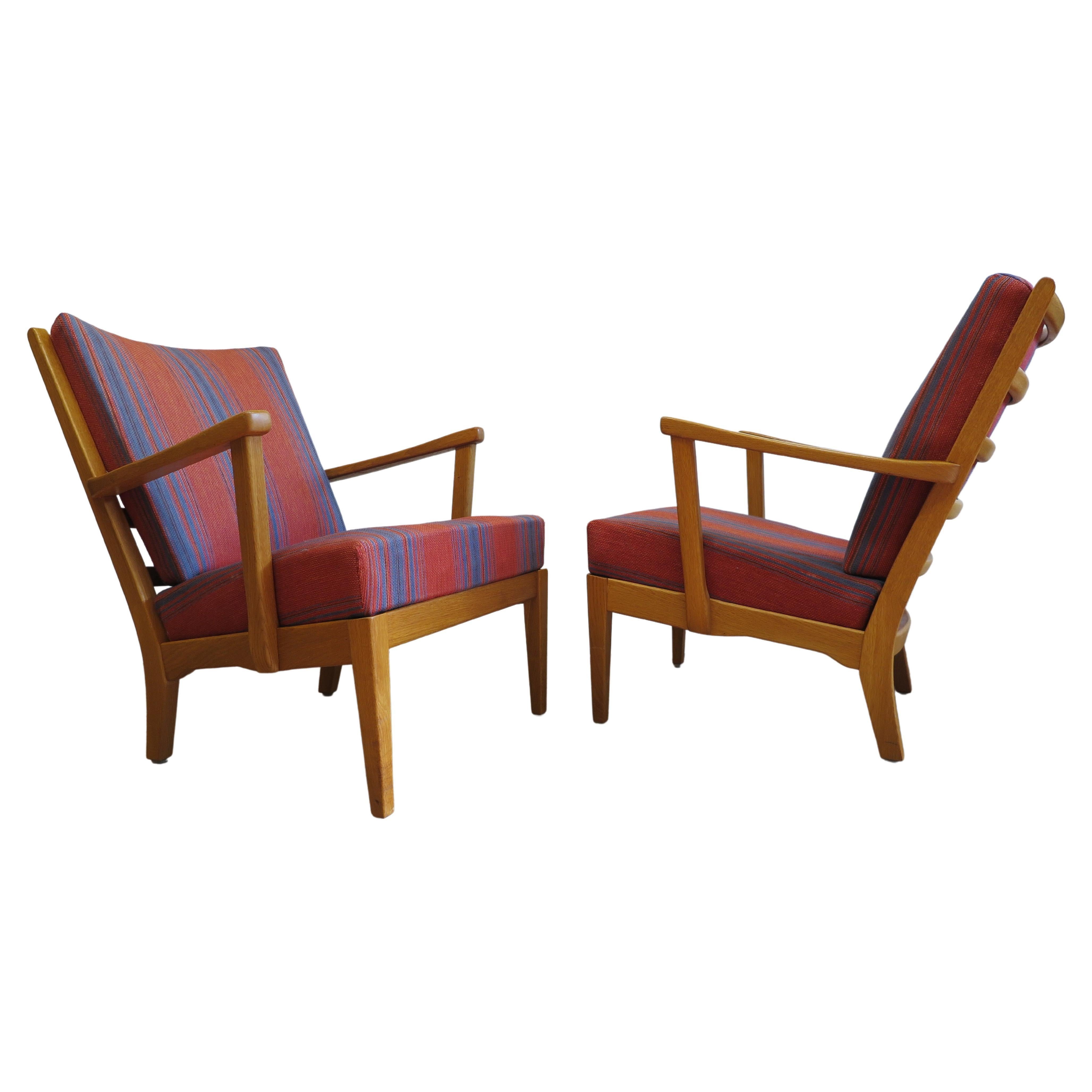 A Pair of Carl Malmsten Visingo Chairs all original. A spectacular pair of Carl Malmsten Visingo Chairs for AB O.H. Sjogren Stoppmobler in Oak. In good original condition complete with original fabric and badges to both chairs. Slight nicks to the