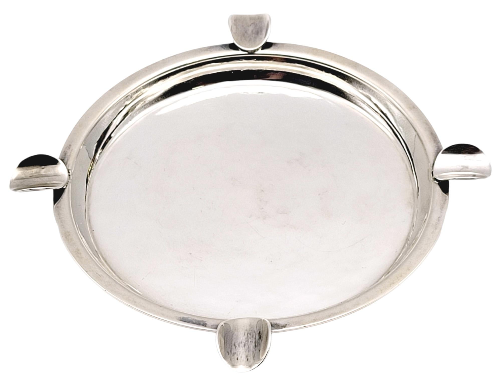 Stunning modern ashtray made of sterling silver. Handmade by the incredible silversmith Carl Poul Peterson. This exceptional piece features a smooth polished finish and four places to rest a cigarette or cigar. The ashtray's center tray is