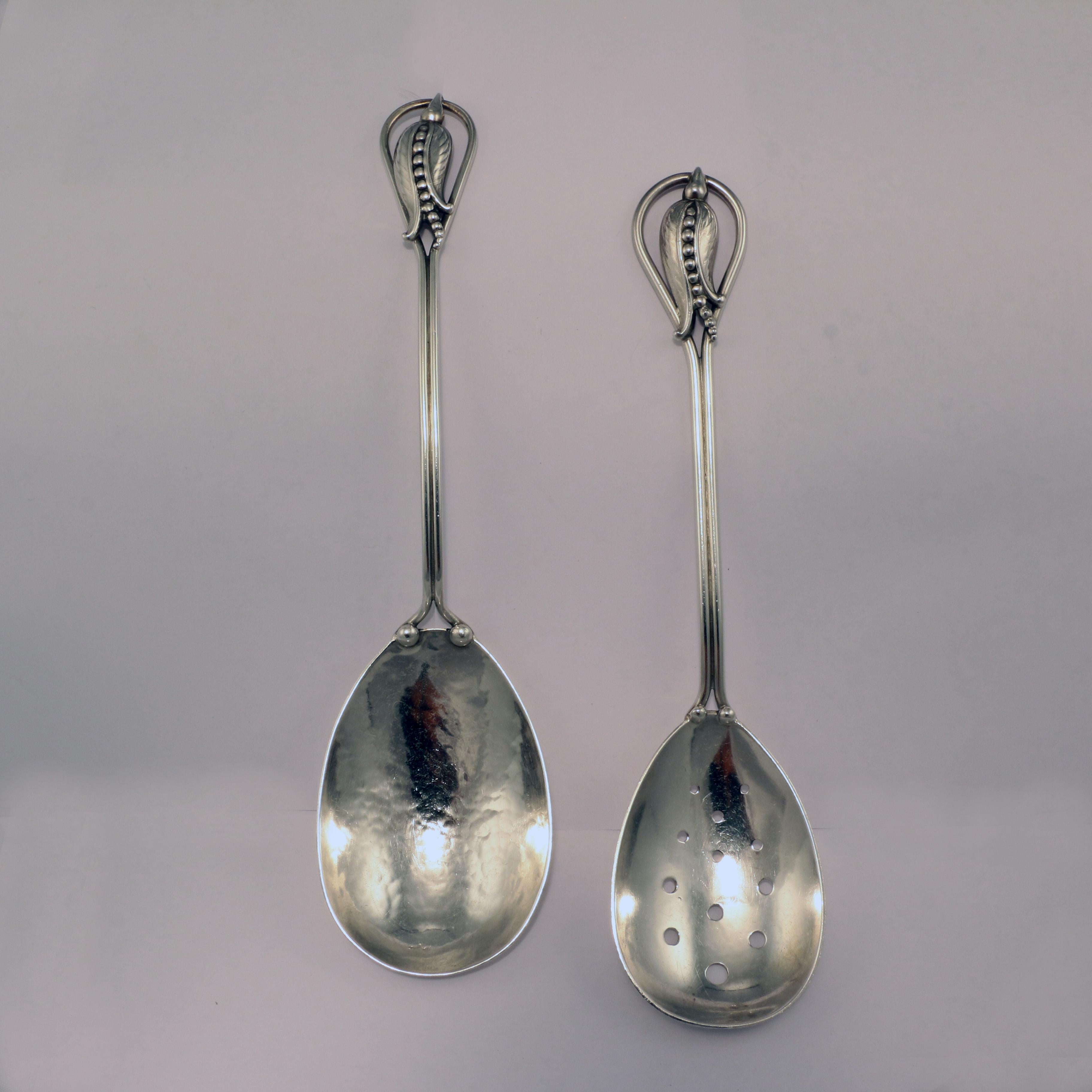 A set consisting of a salad serving spoon and pierced spoon in sterling silver by Karl Poul Petersen in his renowned blossom corn flower pattern.