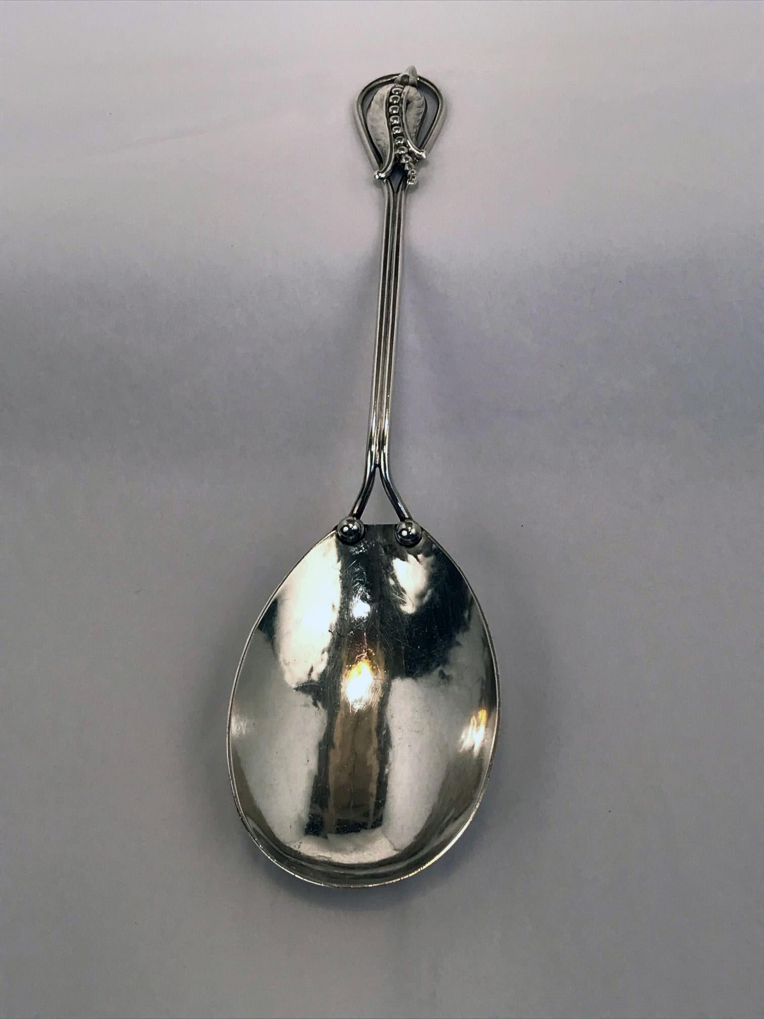 A set consisting of a salad serving spoon and fork in sterling silver by Carl Poul Petersen in his renowned blossom corn flower pattern.