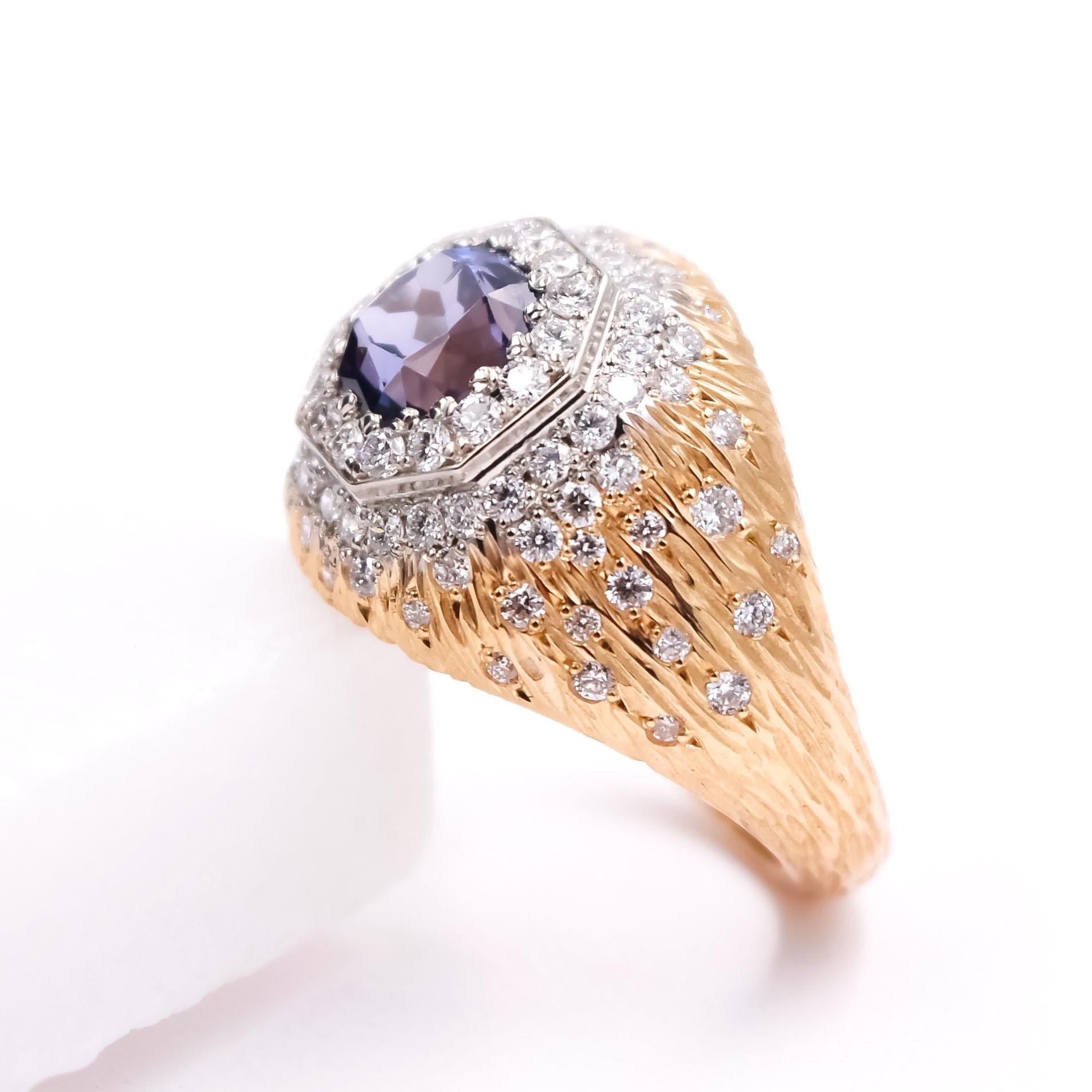 This masterpiece designed by Carl Priolo features a 1.75ct cushion cut Blue Spinel. Surrounding the Blue Spinel is a hexagon shaped pave border in 14k white gold which leads to a mixture of pave and flush set diamonds 