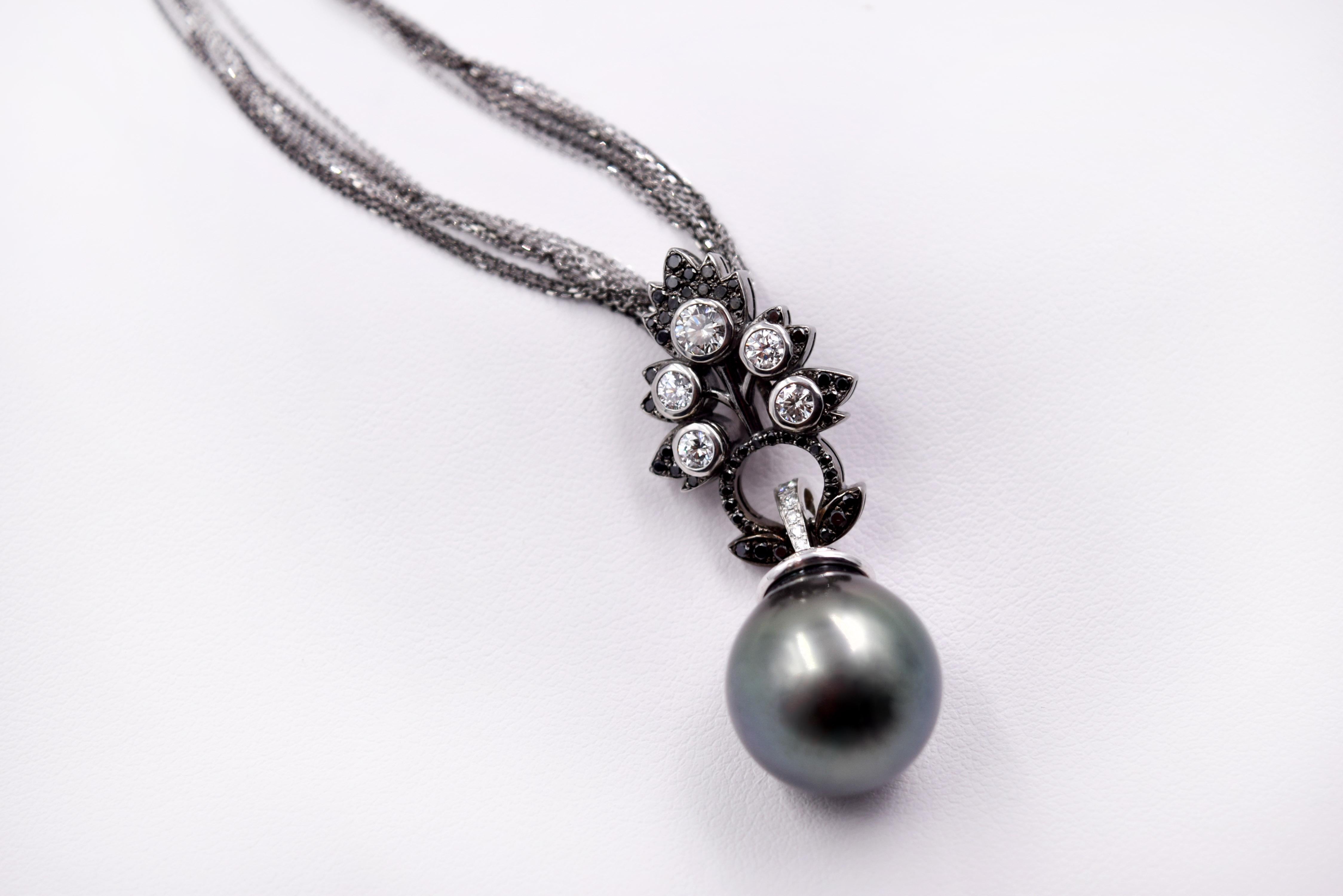 Award winning one of a kind Tahitian pearl pendant designed by Carl Priolo. 
15.50mm cultured Tahitian Pearl, A Grade, great luster. This Pearl is posted with a White Diamond and Black Diamond pave set cap. The stunning design features 5 larger