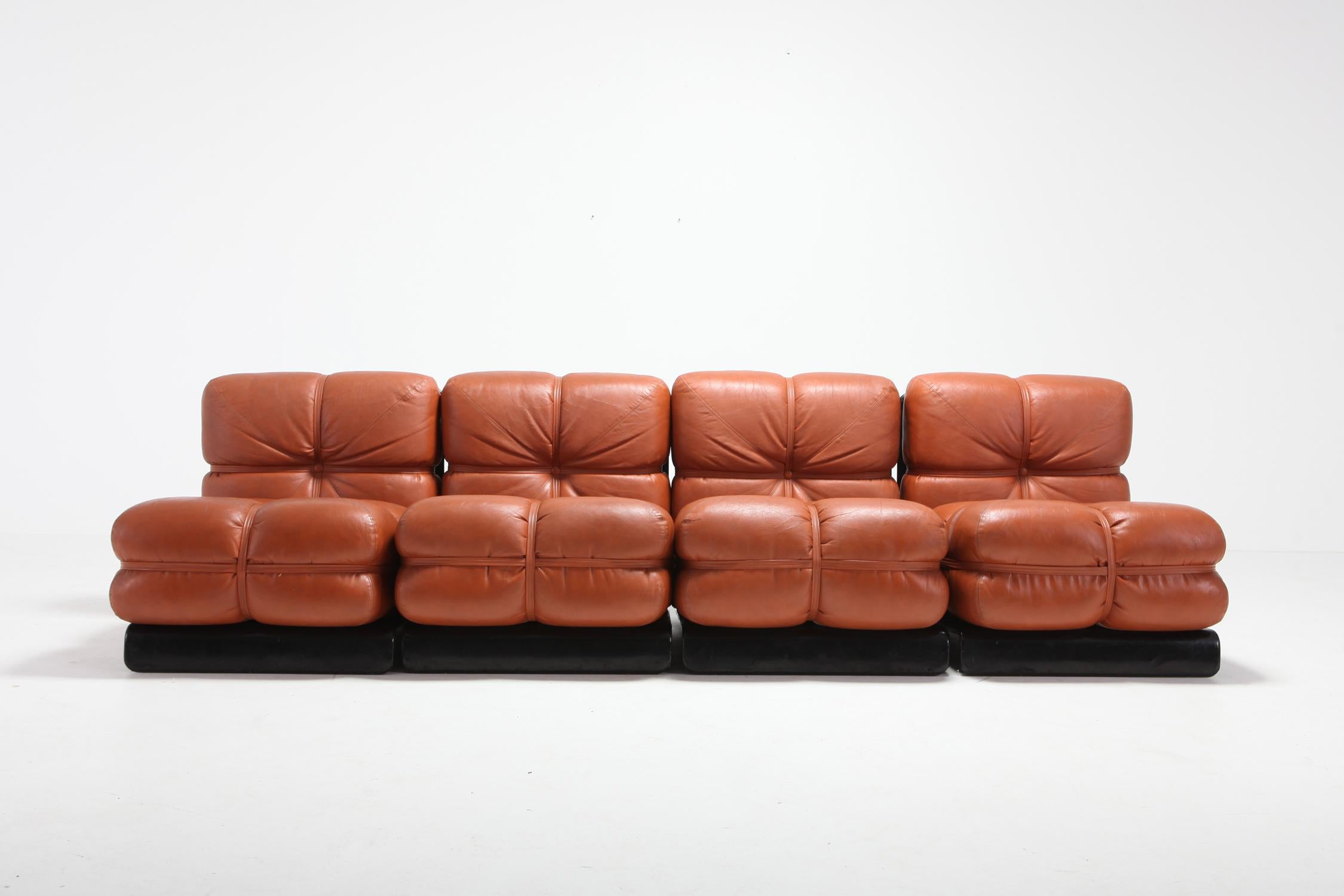 Cognac leather sectional sofa with black lacquered wooden frame by Carla Venosta.
The piece consists out of 4 lounge chairs unattached to create a sofa.

Carla Venosta was a designer and decorator for the beau monde in the 1980s.


 